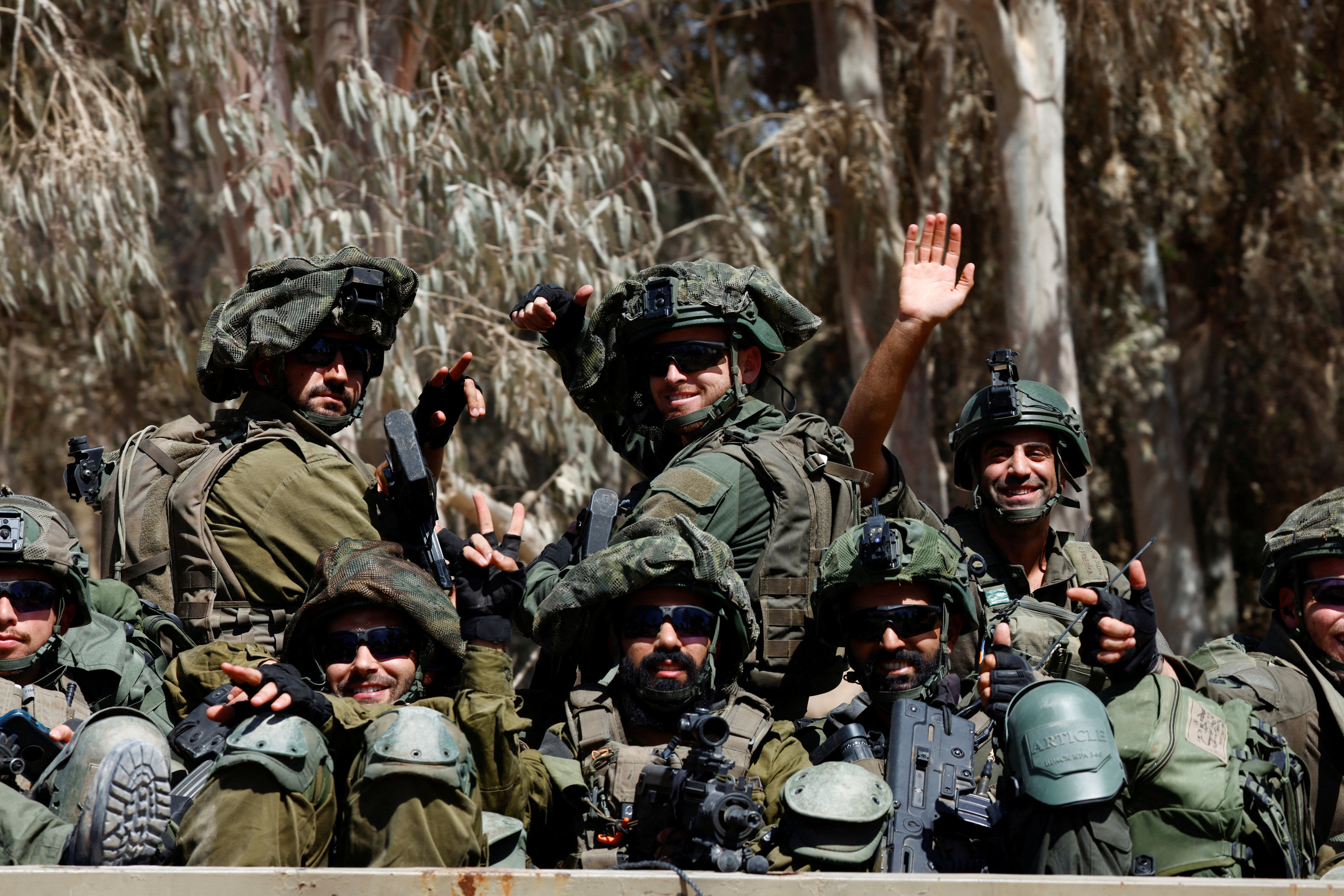 Israeli soldiers on a military truck near the Israel-Gaza border. Photo: Reuters