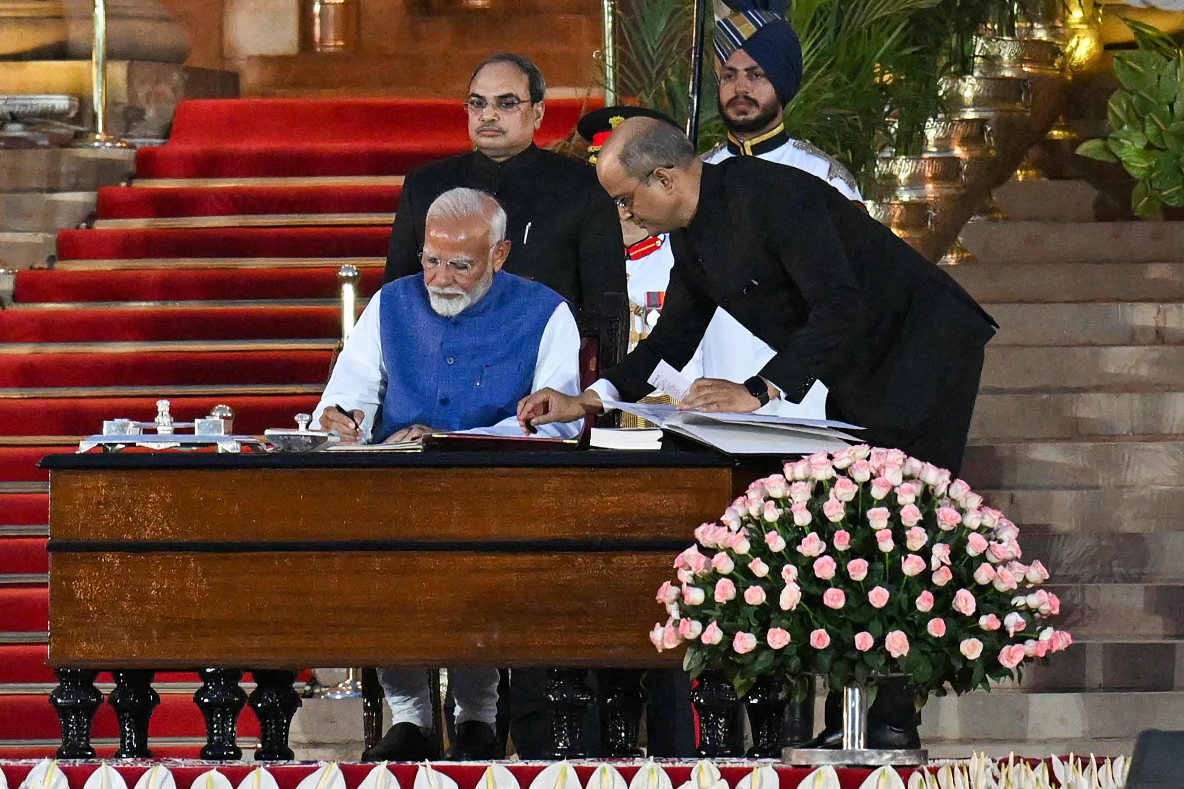India’s Bharatiya Janata Party leader Narendra Modi signs after taking the oath of office for a third term as the country’s prime minister during the oath-taking ceremony in New Delhi. Photo: AFP