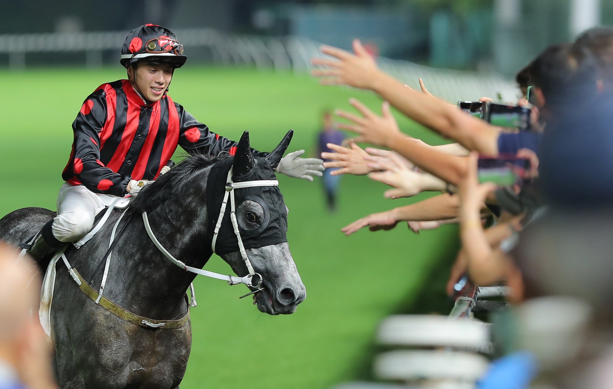 Angus Chung high-fives the Happy Valley crowd after booting home Outgate.