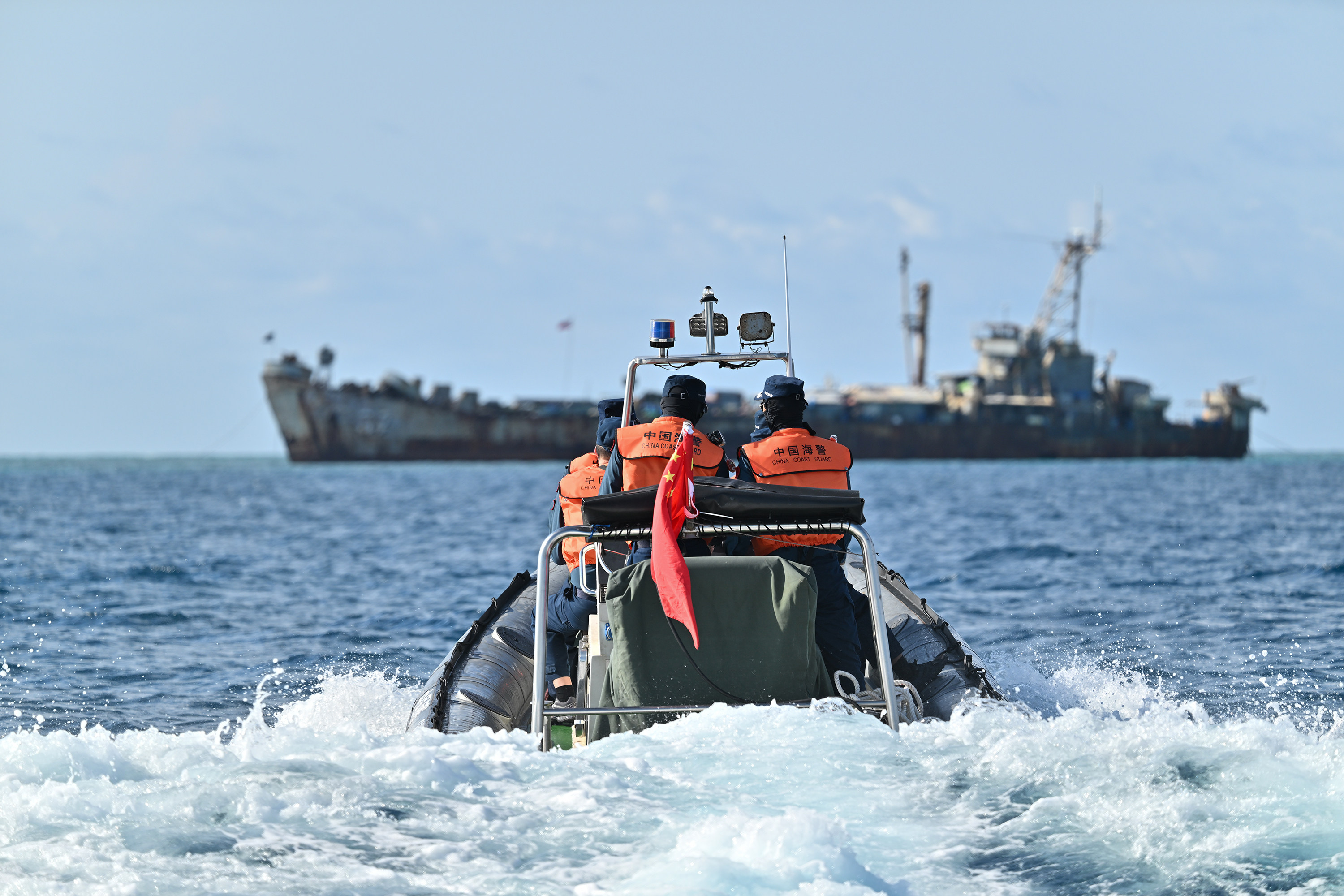 Law enforcers of China’s coastguard inspect near a grounded Philippine navy transport ship last month. Photo: Xinhua