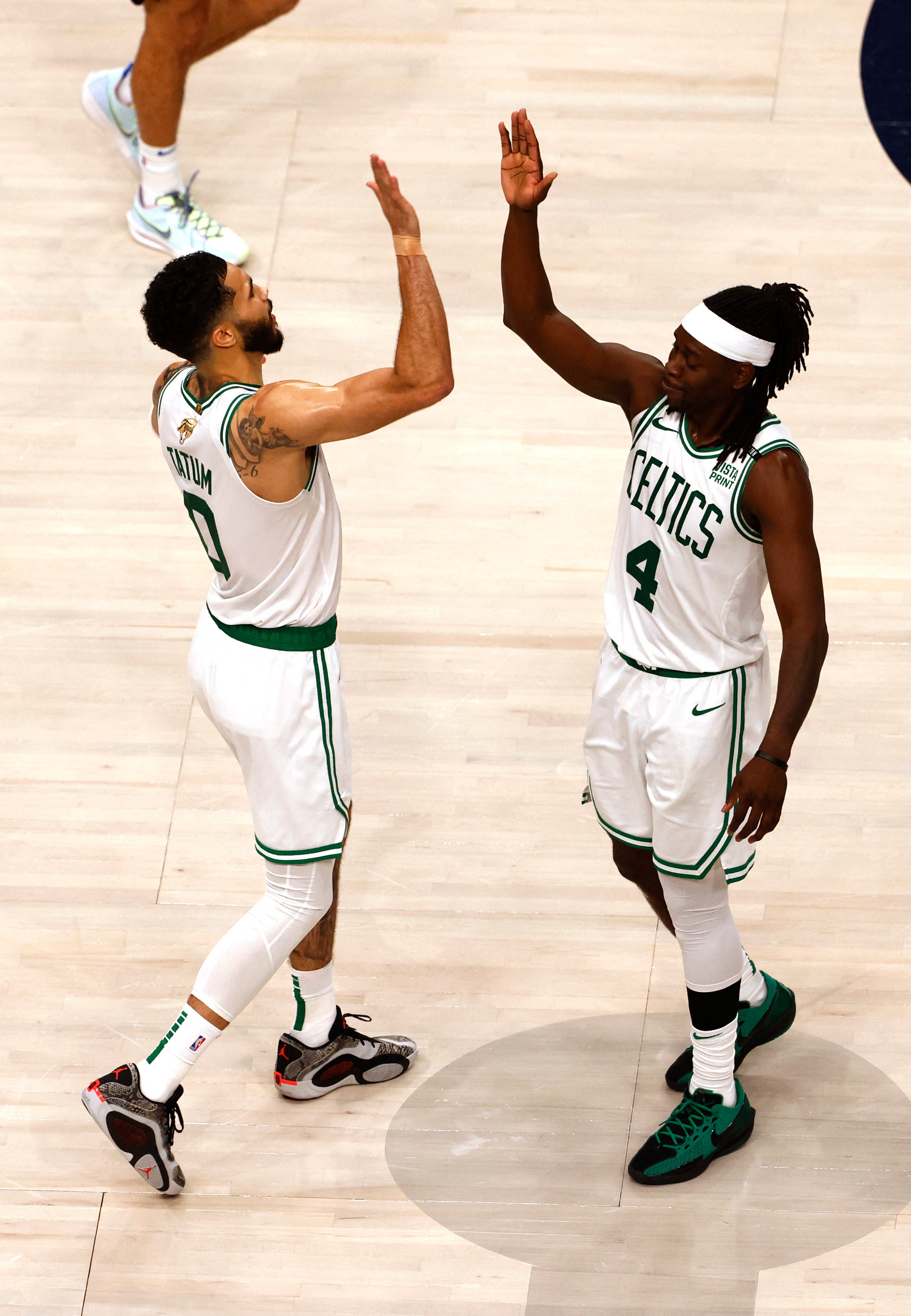 Boston Celtics stars Jayson Tatum (0) and guard Jrue Holiday (4) celebrate after defeat of Dallas Mavericks. Photo: Reuters
