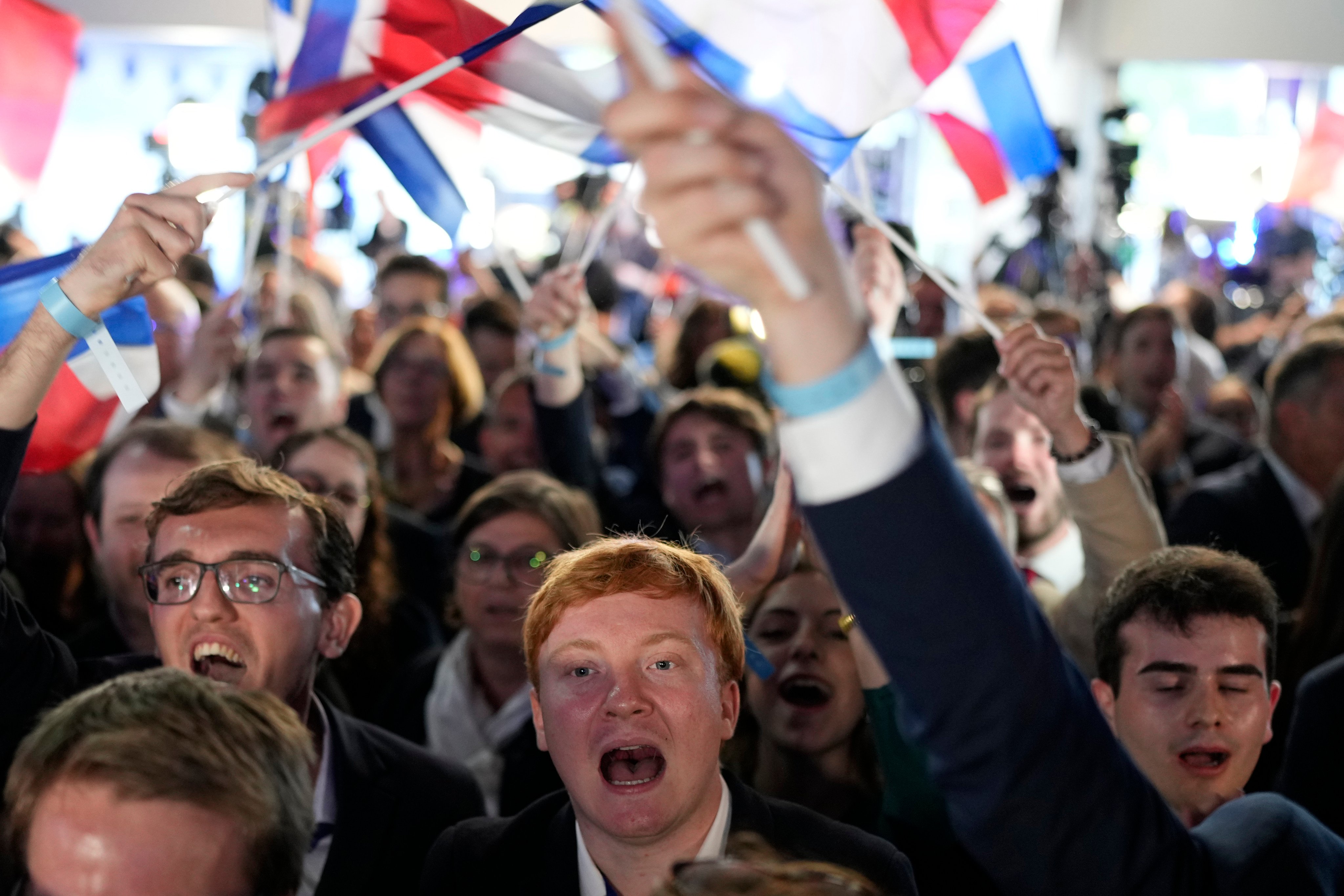 Supporters of the French far-right party, National Rally, react to the European election on June 9 in Paris, France. Photo: AP
