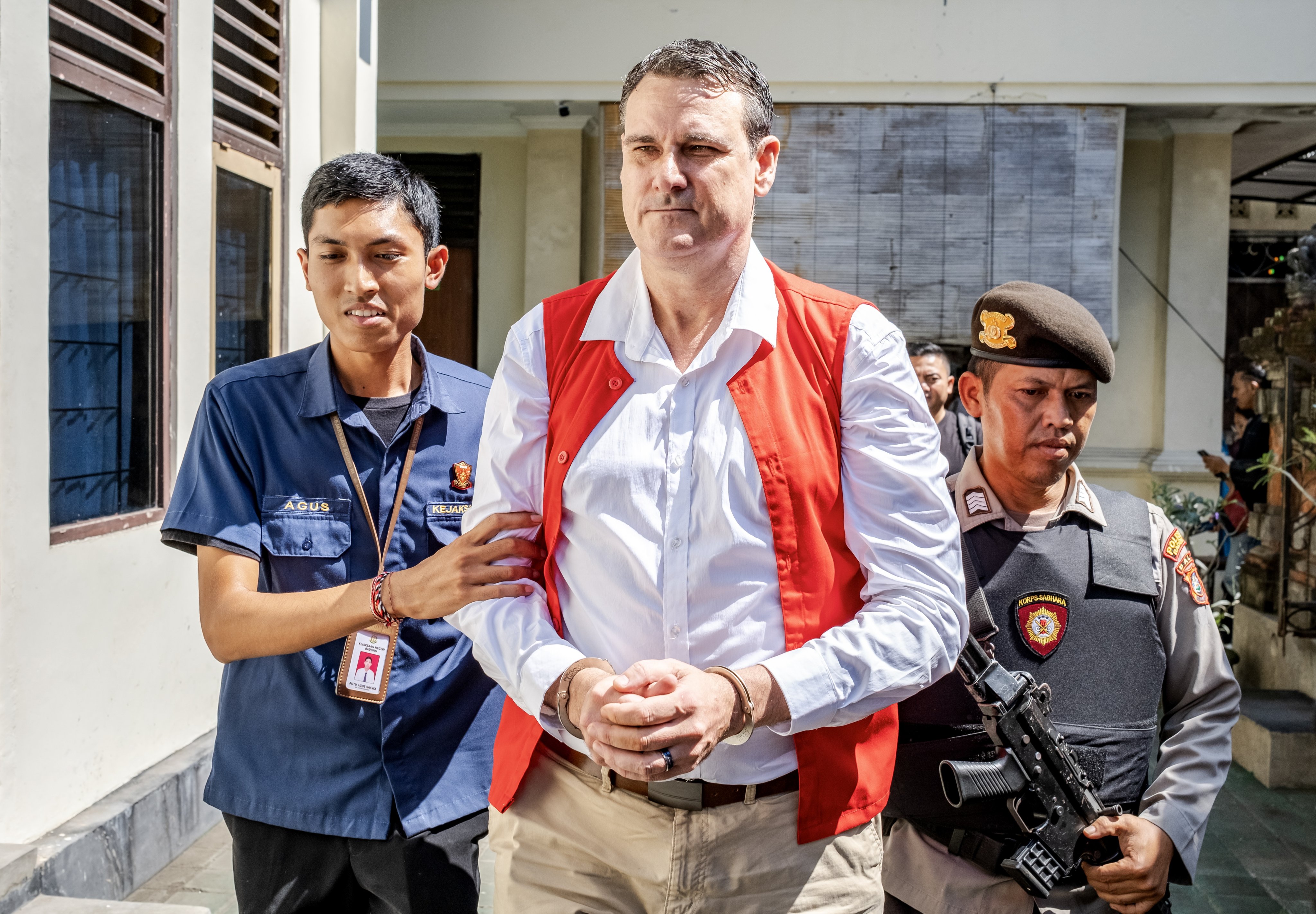 Troy Smith is escorted to his trial, in Bali, Indonesia on Thursday. The Australian was arrested on April 30 by the Indonesian police after being allegedly found in possession of methamphetamine. Photo: EPA-EFE