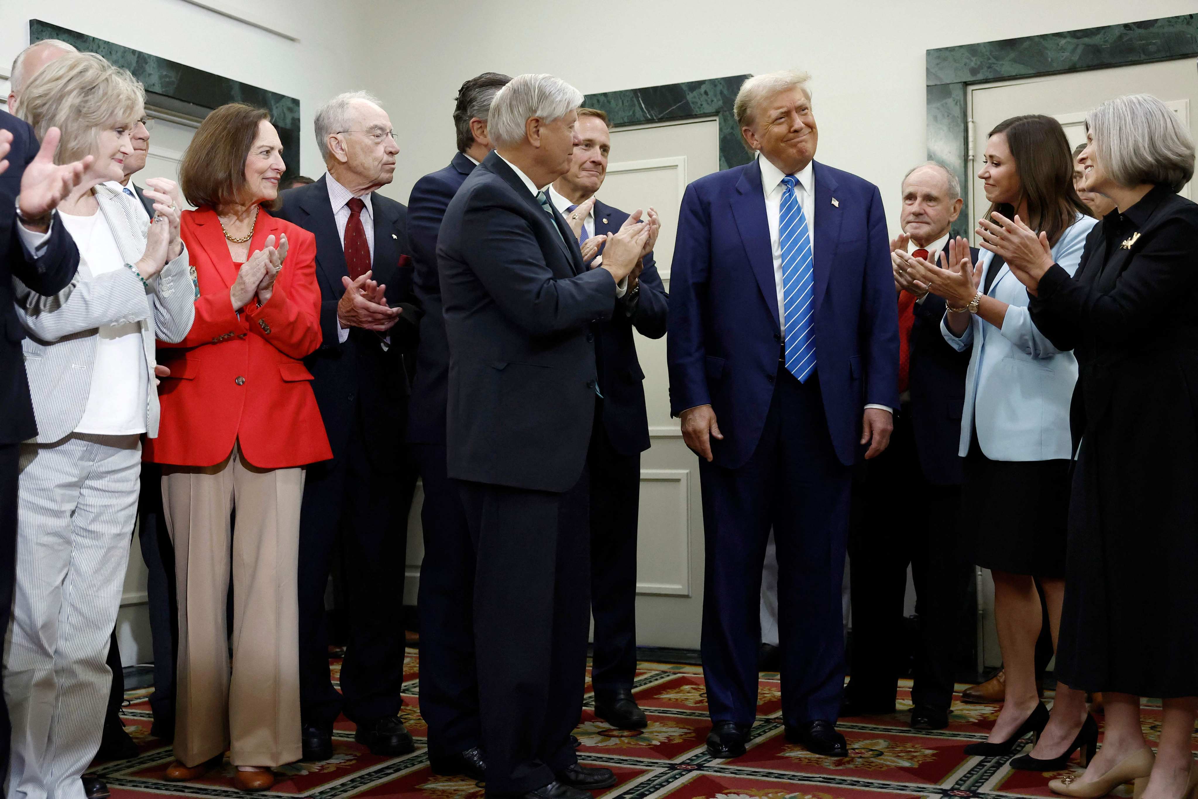 Donald Trump being applauded by Senate Republicans in Washington on Thursday. Photo: AFP 