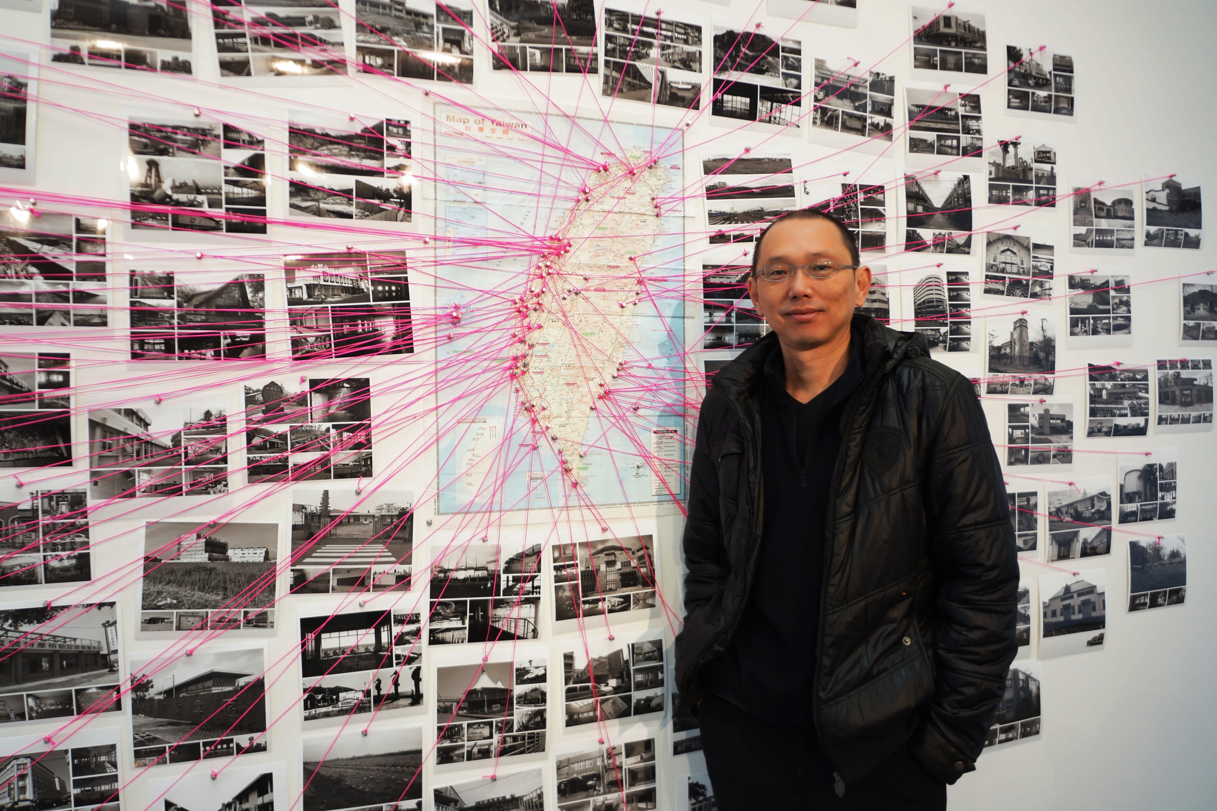 Yao Jui-chung with a map of abandoned buildings around Taiwan and photographs he and his students have taken of them. Photo: Wen Chih-yin