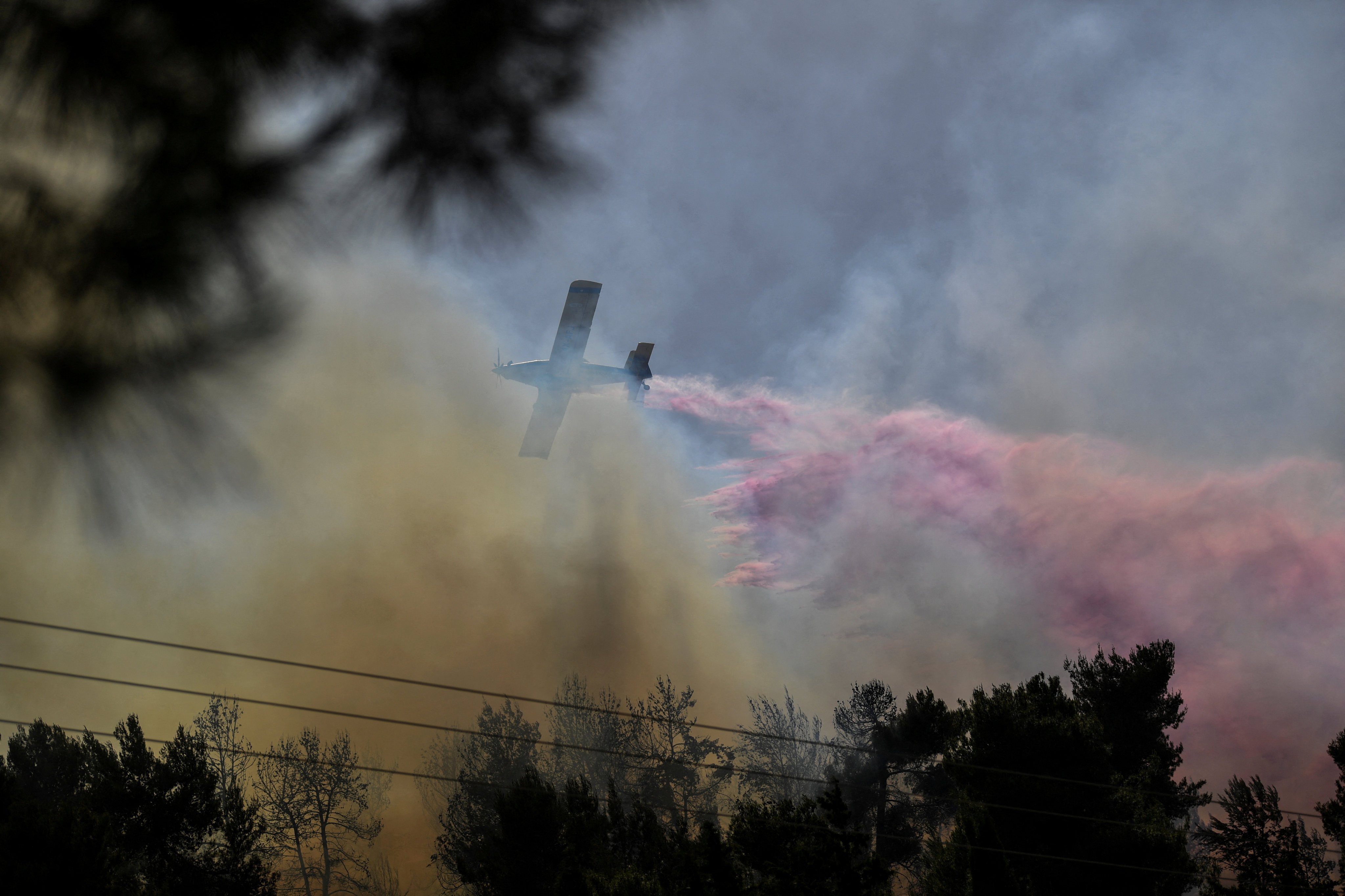 A firefighting plane in northern Israel extinguishes a fire after rockets were launched from Lebanon. Photo: Reuters