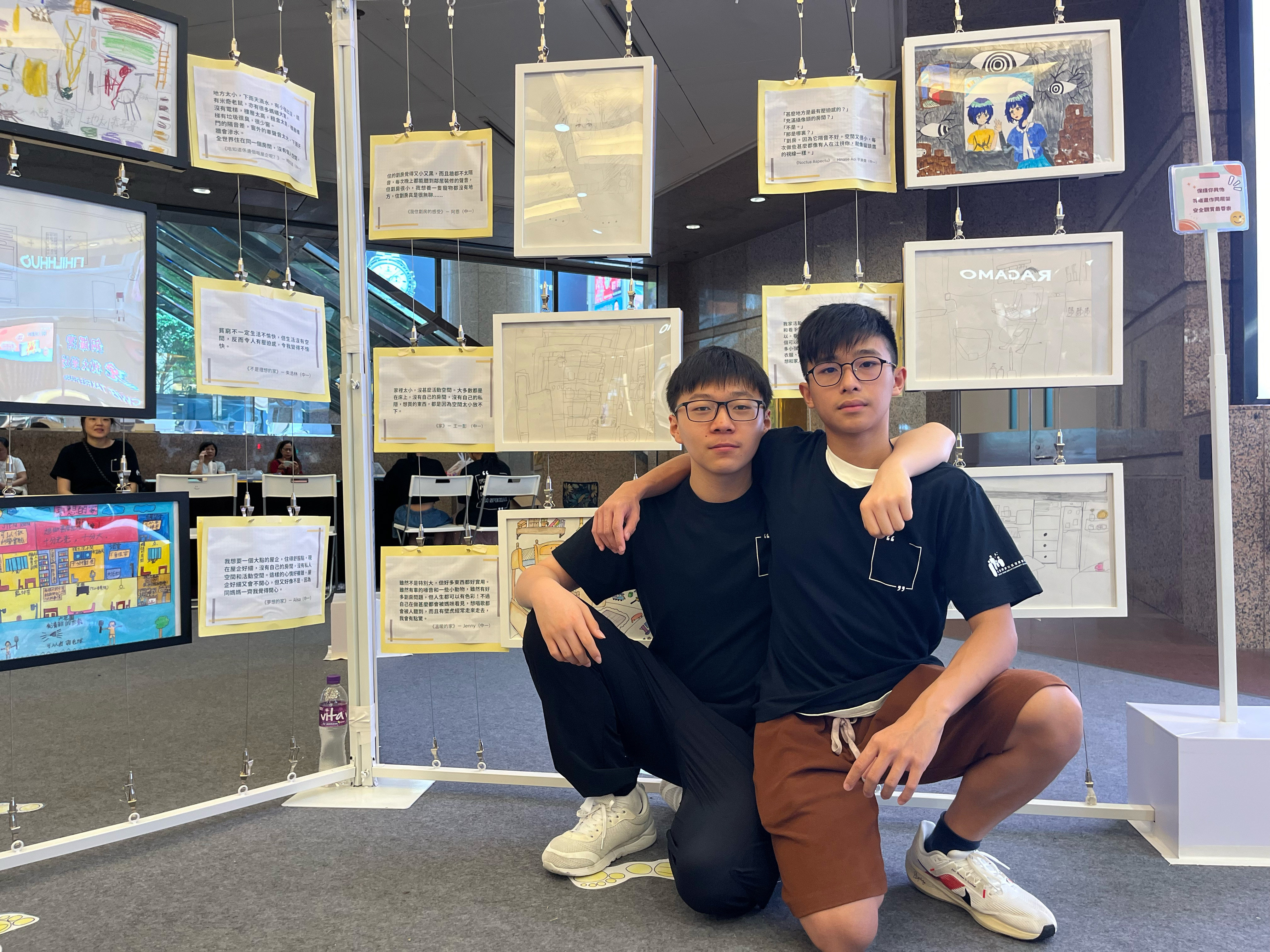 Secondary school students Matthew Wang (left) and Gordan Jian have written stories and created drawings to reflect their experiences living in subdivided flats. Photo: Kelly Fung