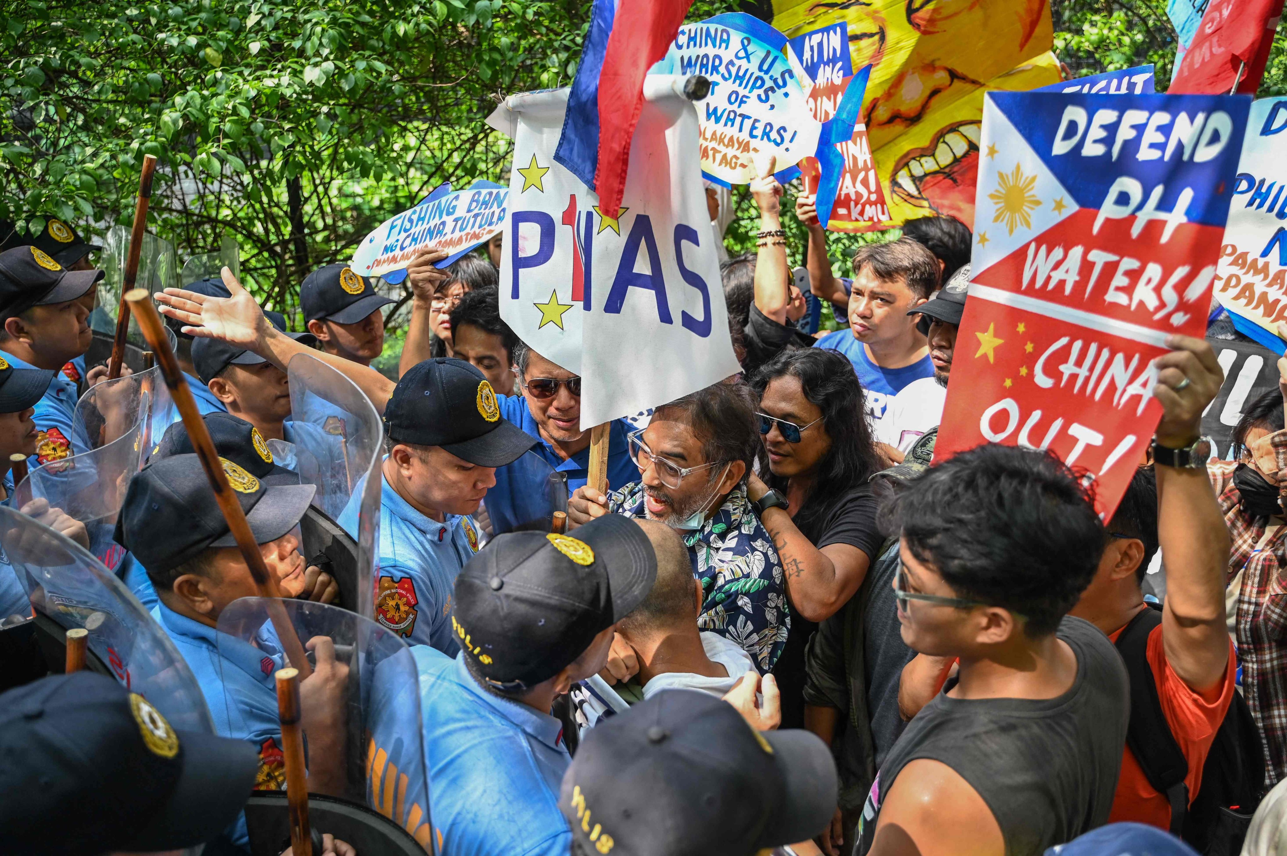 Police block protesters during a rally in front of the Chinese Consulate in Manila on June 14. Photo: AFP