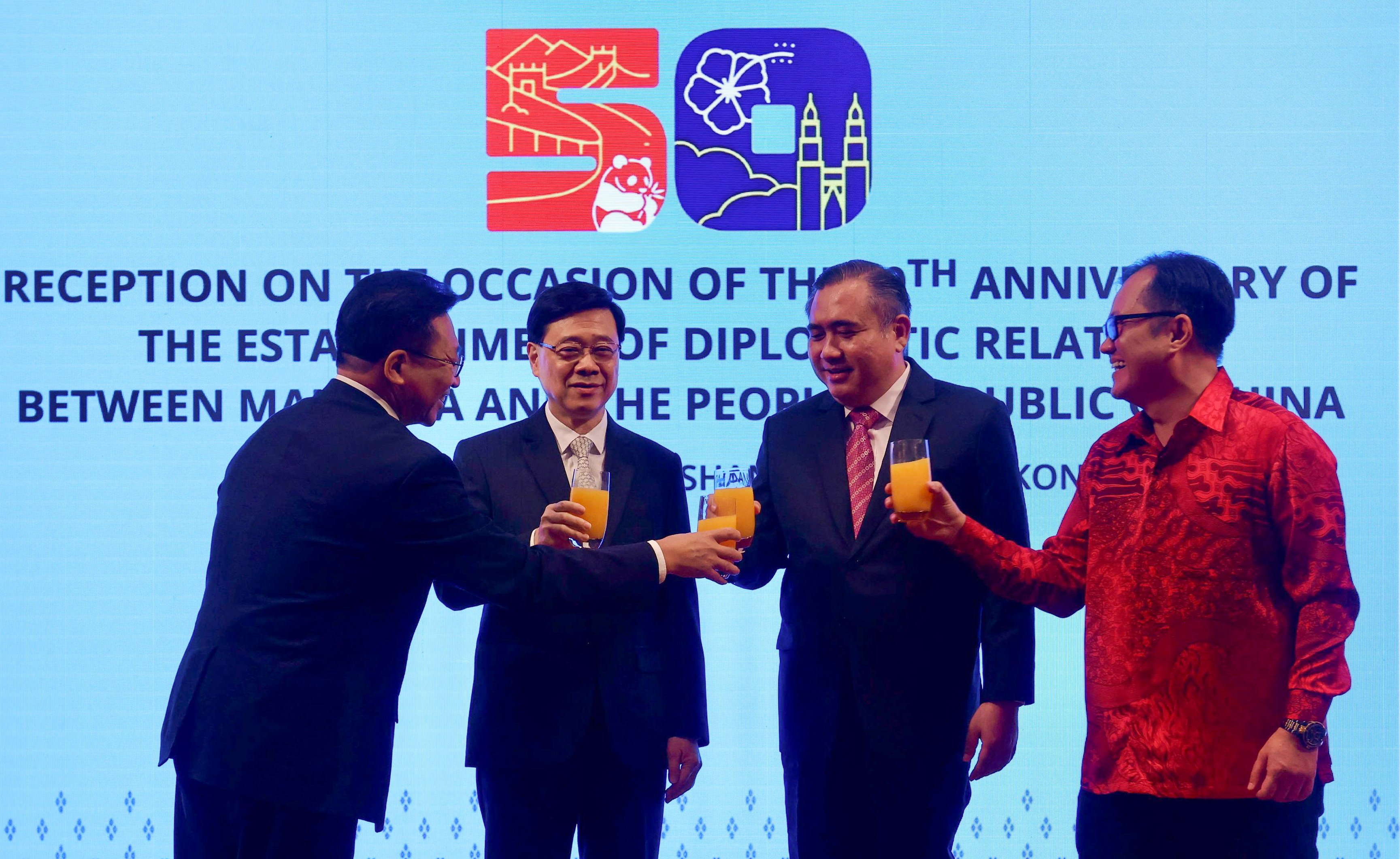 Malaysia’s Transport Minister Anthony Loke shares a toast with Hong Kong Chief Executive John Lee Ka-chiu and other officials on June 6. Photo: Jonathan Wong