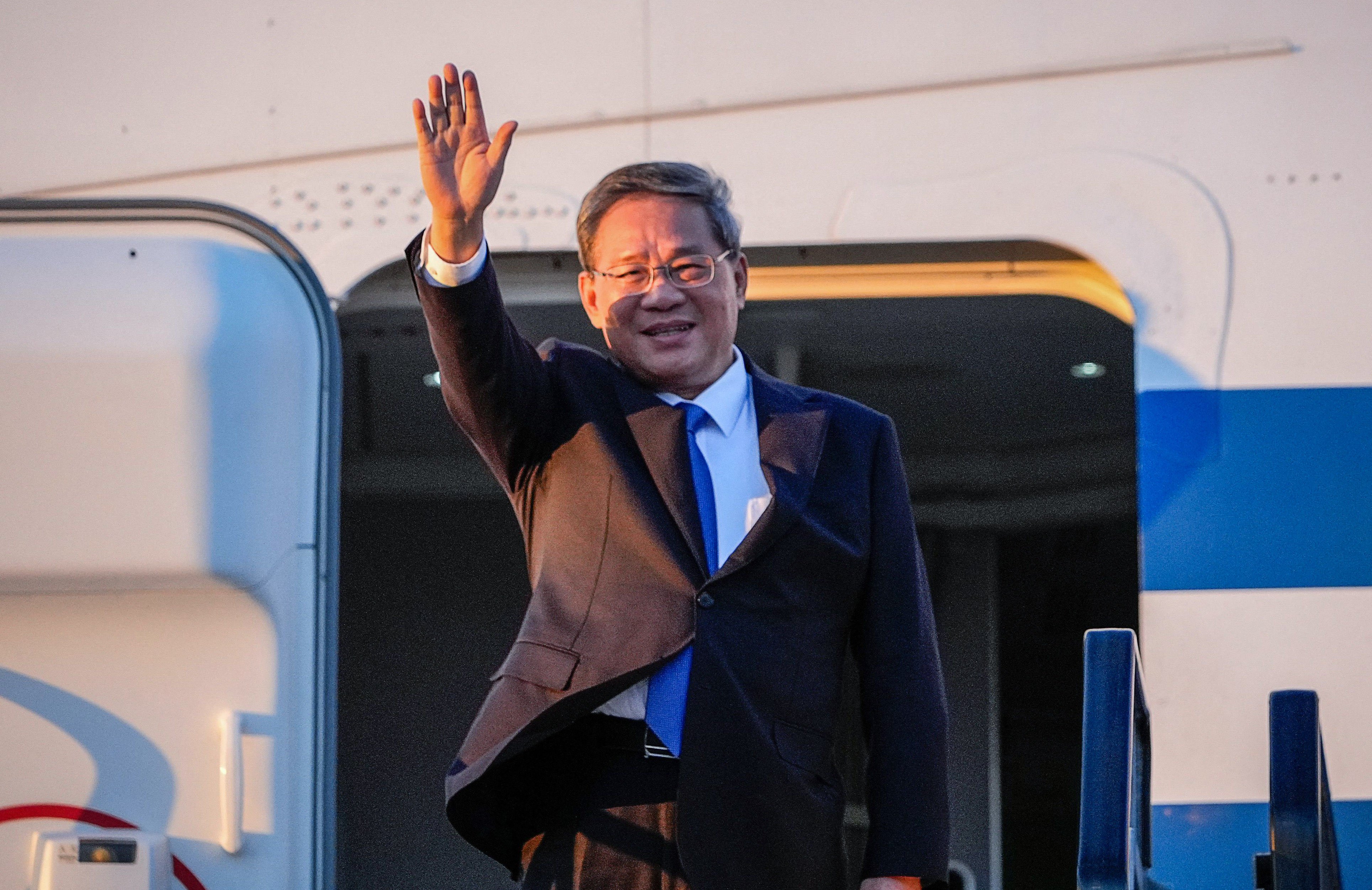 China’s Premier Li Qiang waves as he arrives at Adelaide Airport. Photo: AFP