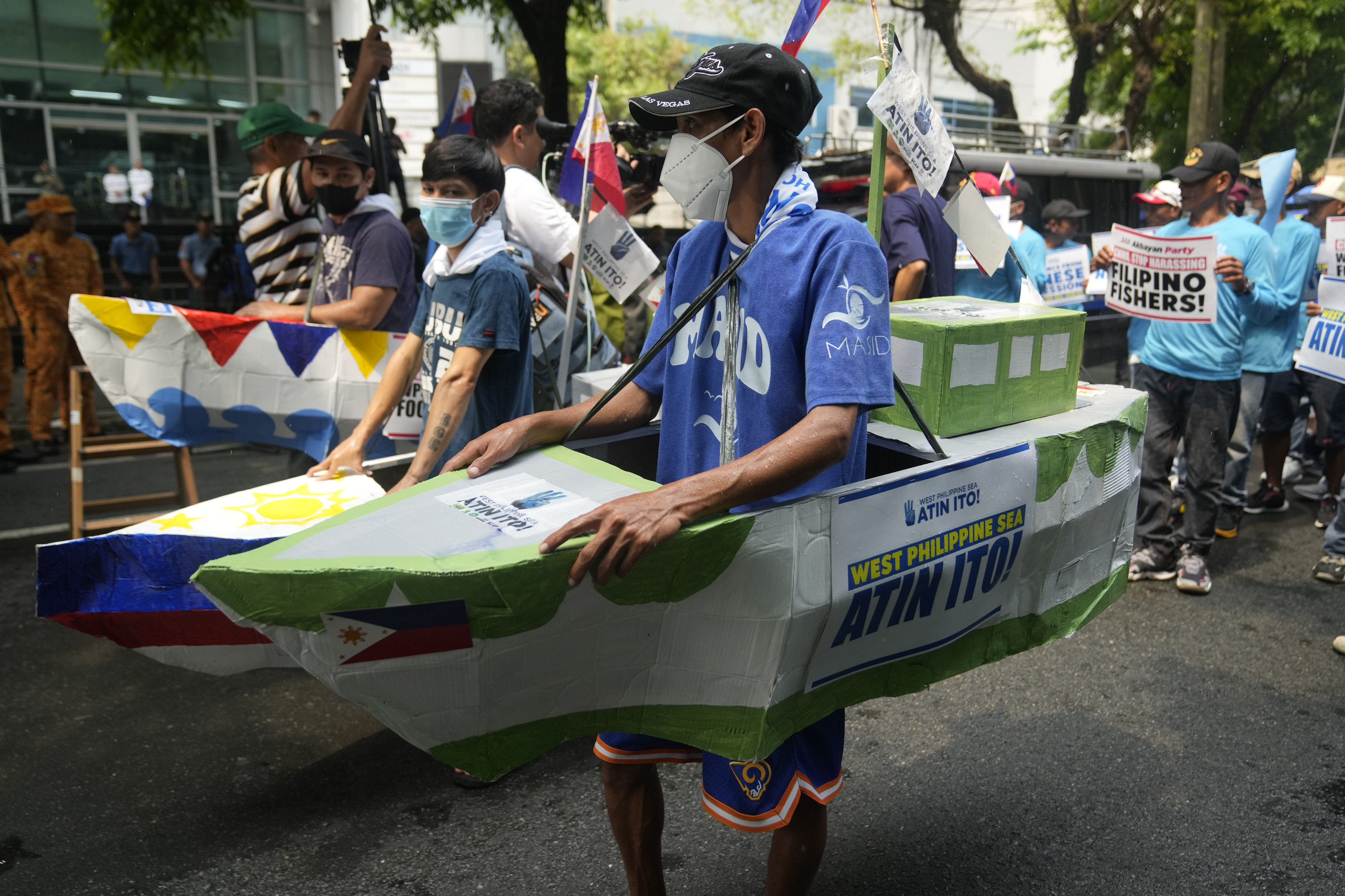 Filipino fishermen and activists wear boat costumes to protest against alleged Chinese aggression in the disputed South China Sea during a rally in Makati on June 11. Photo: AP