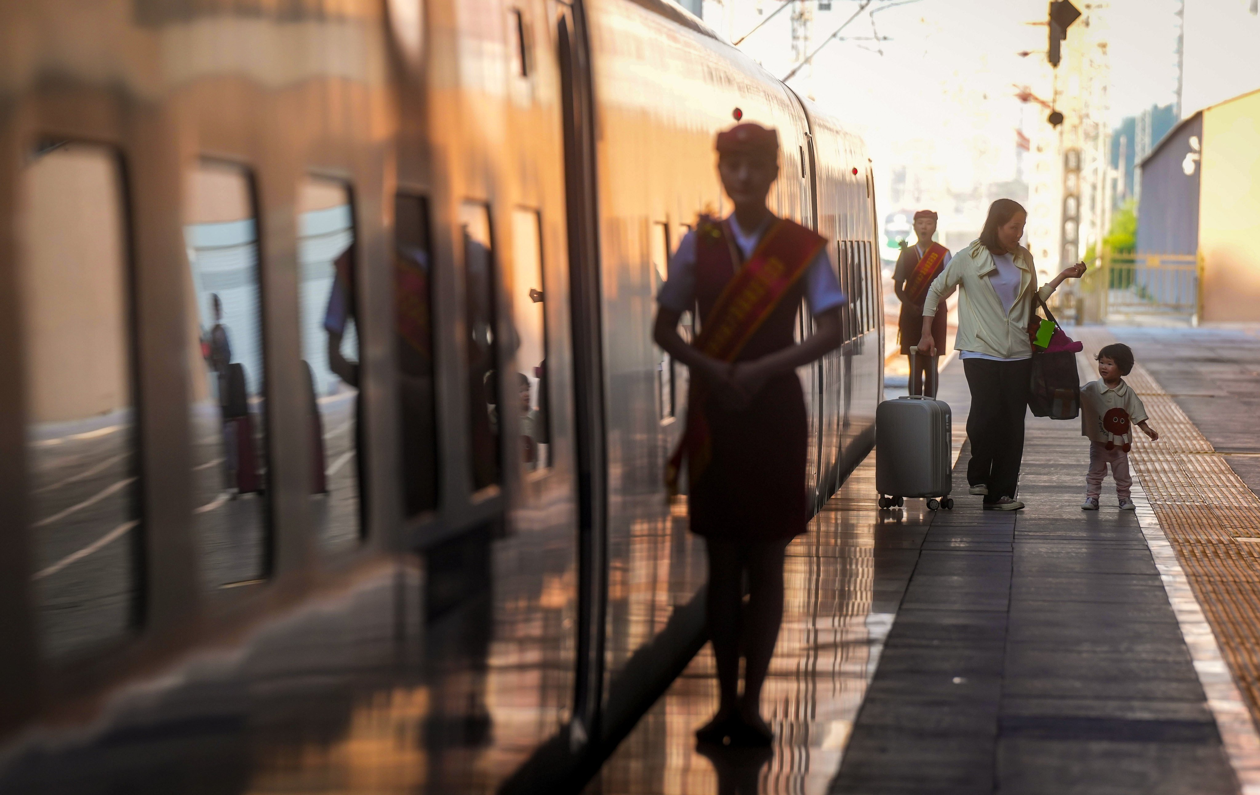 Passengers get off a high-speed sleeper train after it arrives in Beijing. Photo: Elson Li