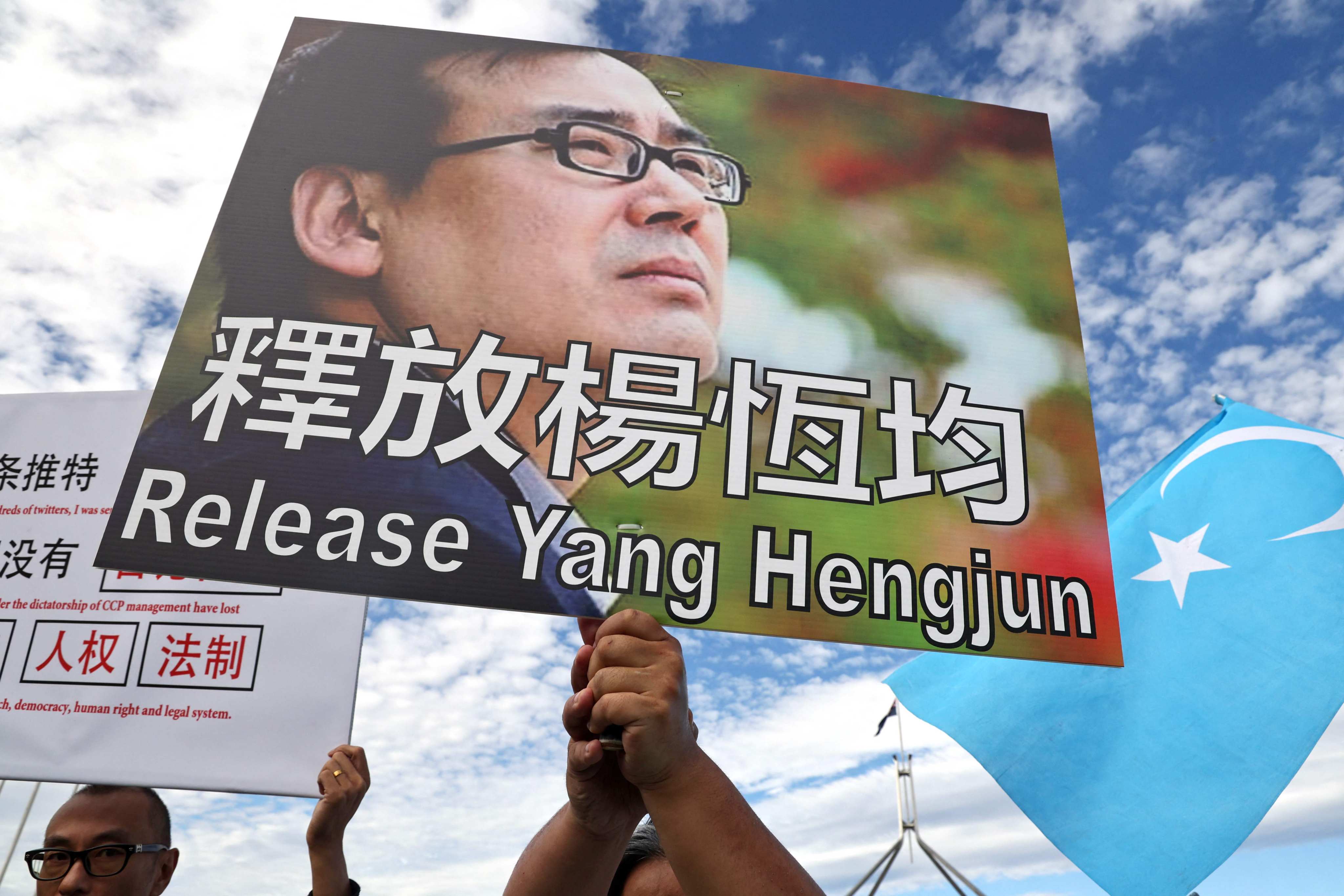 Protesters hold placards demanding the release of writer and businessman Yang Hengjun during a rally outside Parliament House in Canberra in March. Photo: AFP