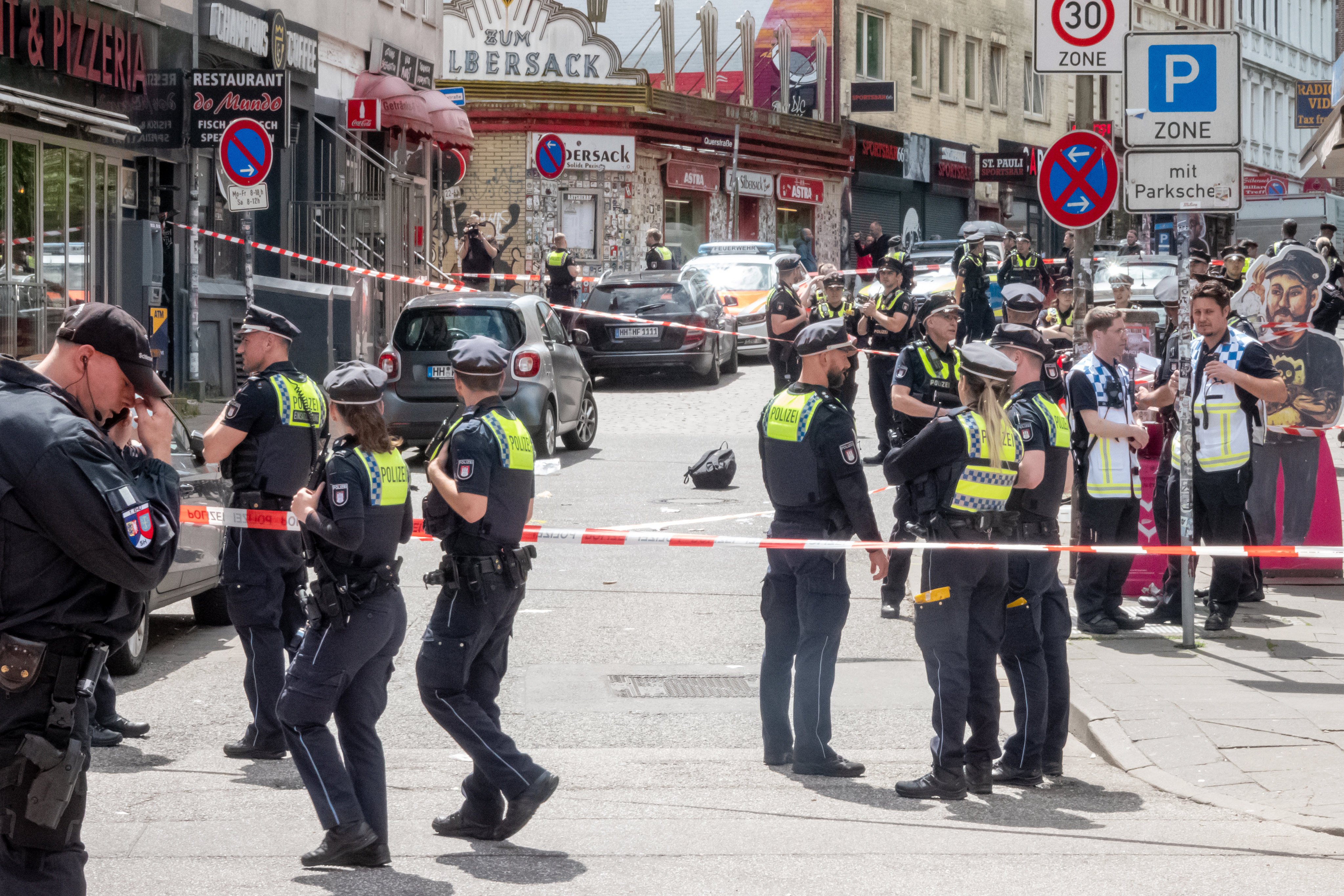 Police at the scene after officers shot a man armed with a pickaxe and a Molotov cocktail near the Reeperbahn in Hamburg-St Pauli, Germany on Sunday. Photo: dpa