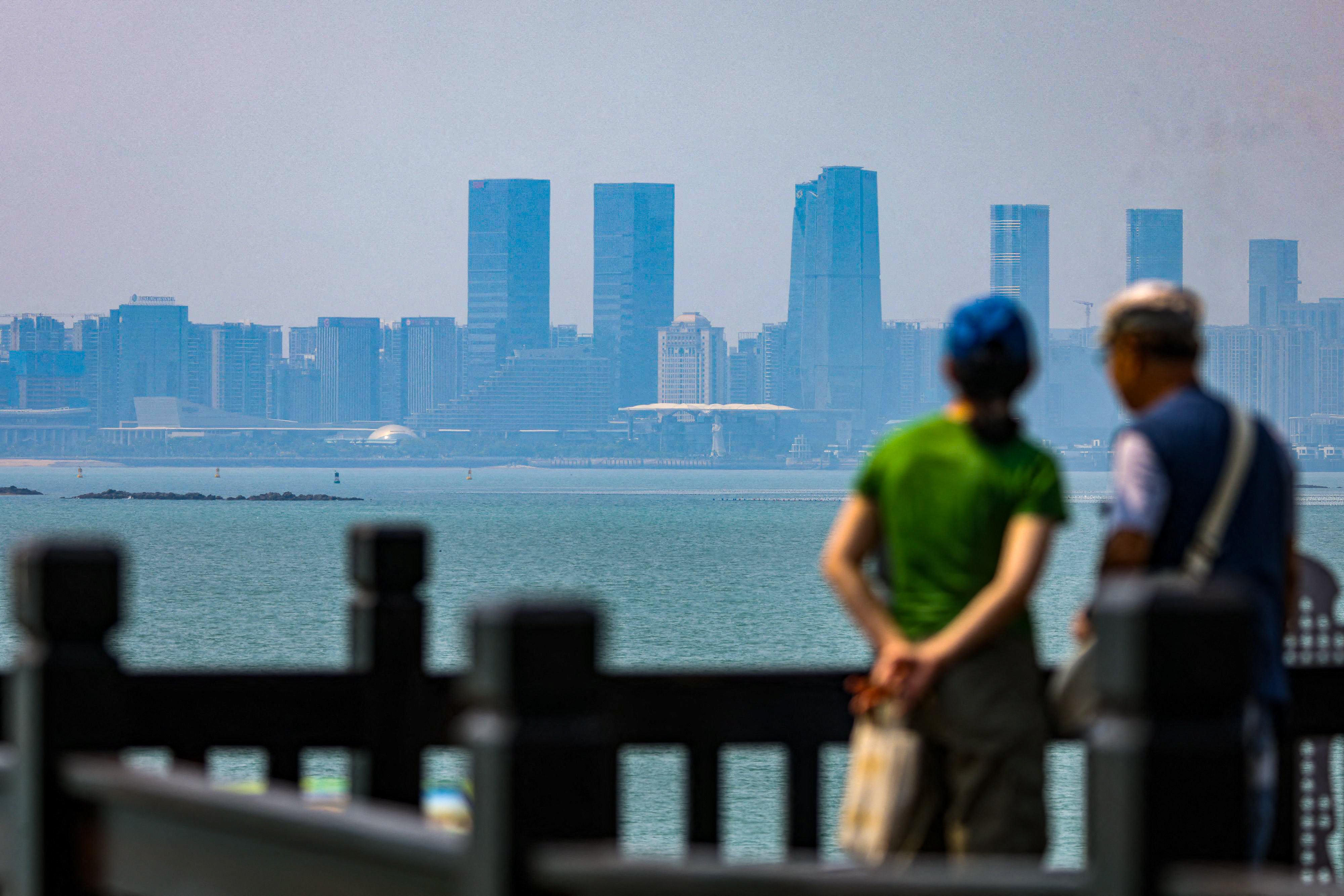 Tourists look at the mainland Chinese city Xiamen, from Taipei-governed Quemoy Island. Photo: AFP