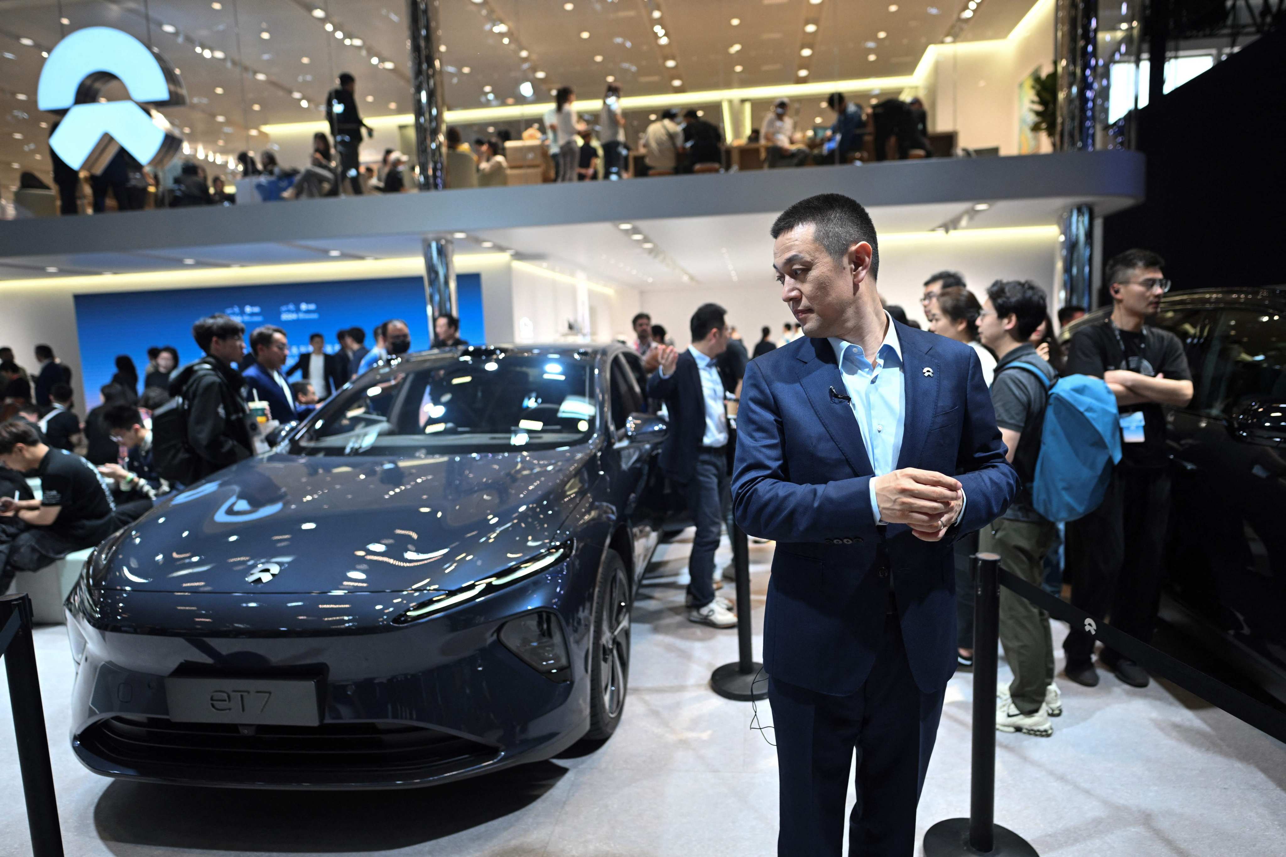 William Li, CEO of Chinese EV maker Nio, stands next to the company’s ET7 model during an interview at the Beijing Auto Show on April 25, 2024. Photo: AFP