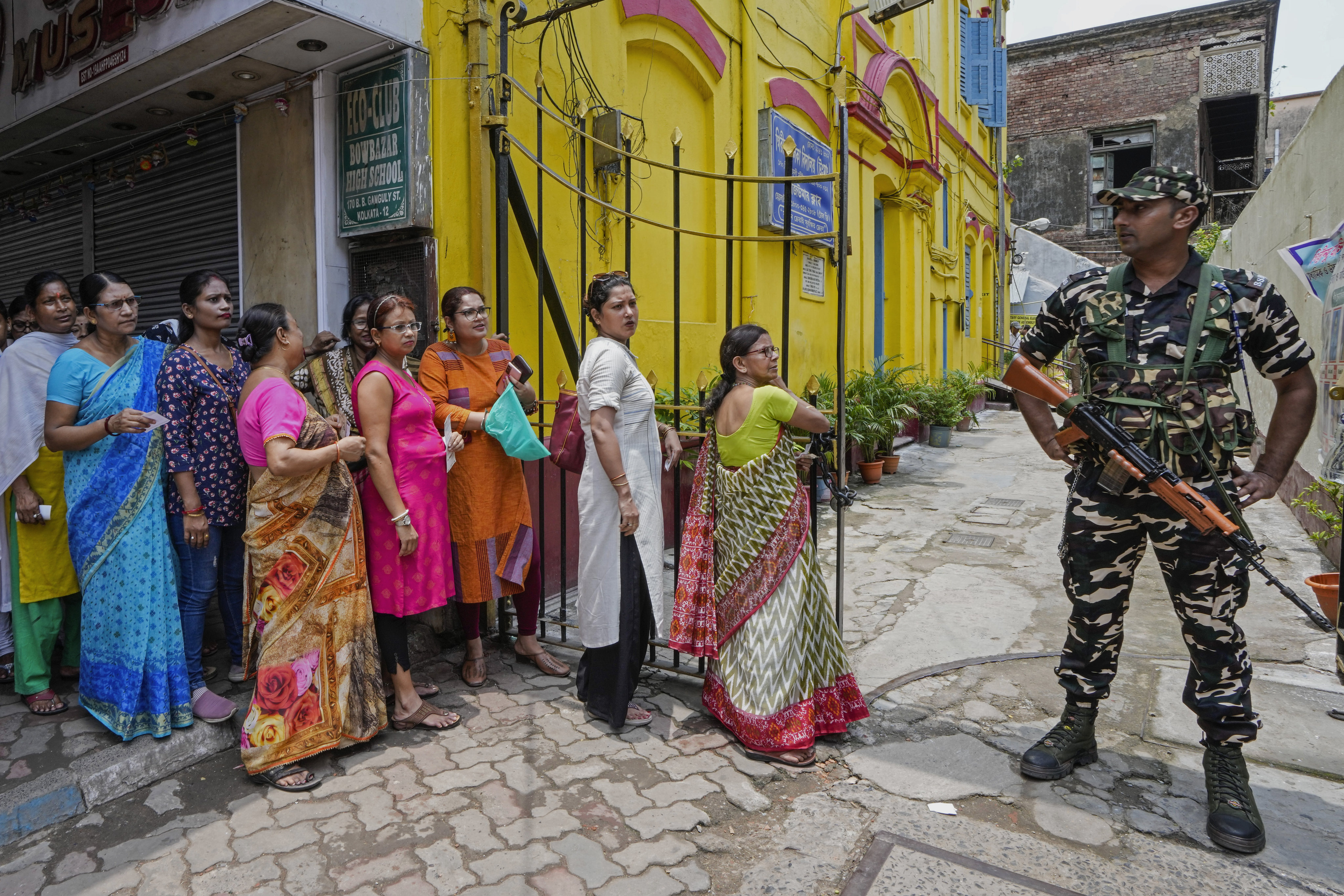 A paramilitary soldier stands guard as women queue up to cast their votes at a polling station during the seventh and final phase of national elections in Kolkata, India, on June 1. Indian women’s political participation has made significant progress, but their participation in the country’s workforce still lags behind much of the world. Photo: AP