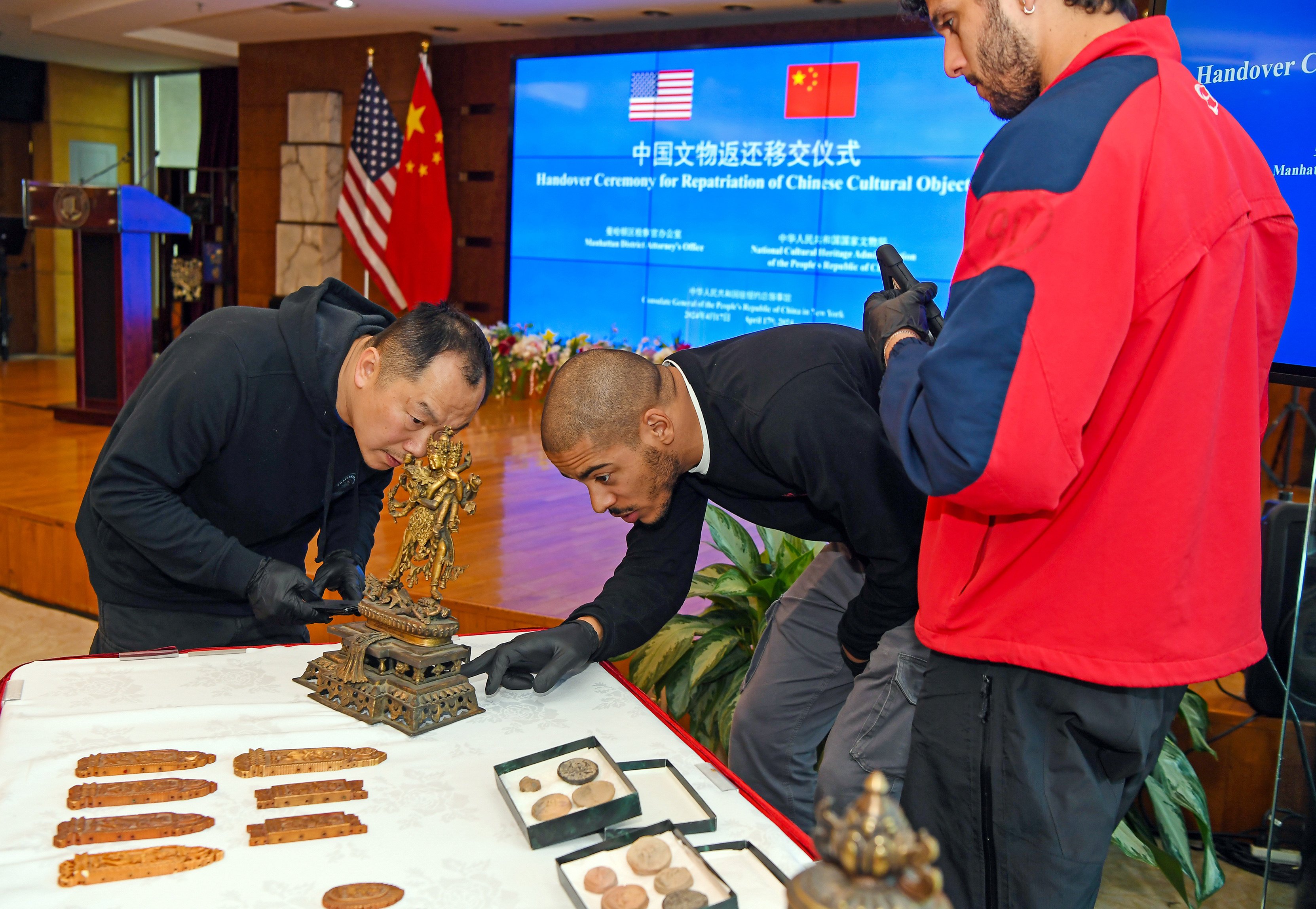 Staff members check the condition of ancient Chinese artefacts at a handover ceremony at the Chinese Consulate General in New York City on April 17. The US has played a useful role in the return of Chinese artefacts to China. Photo: Xinhua
