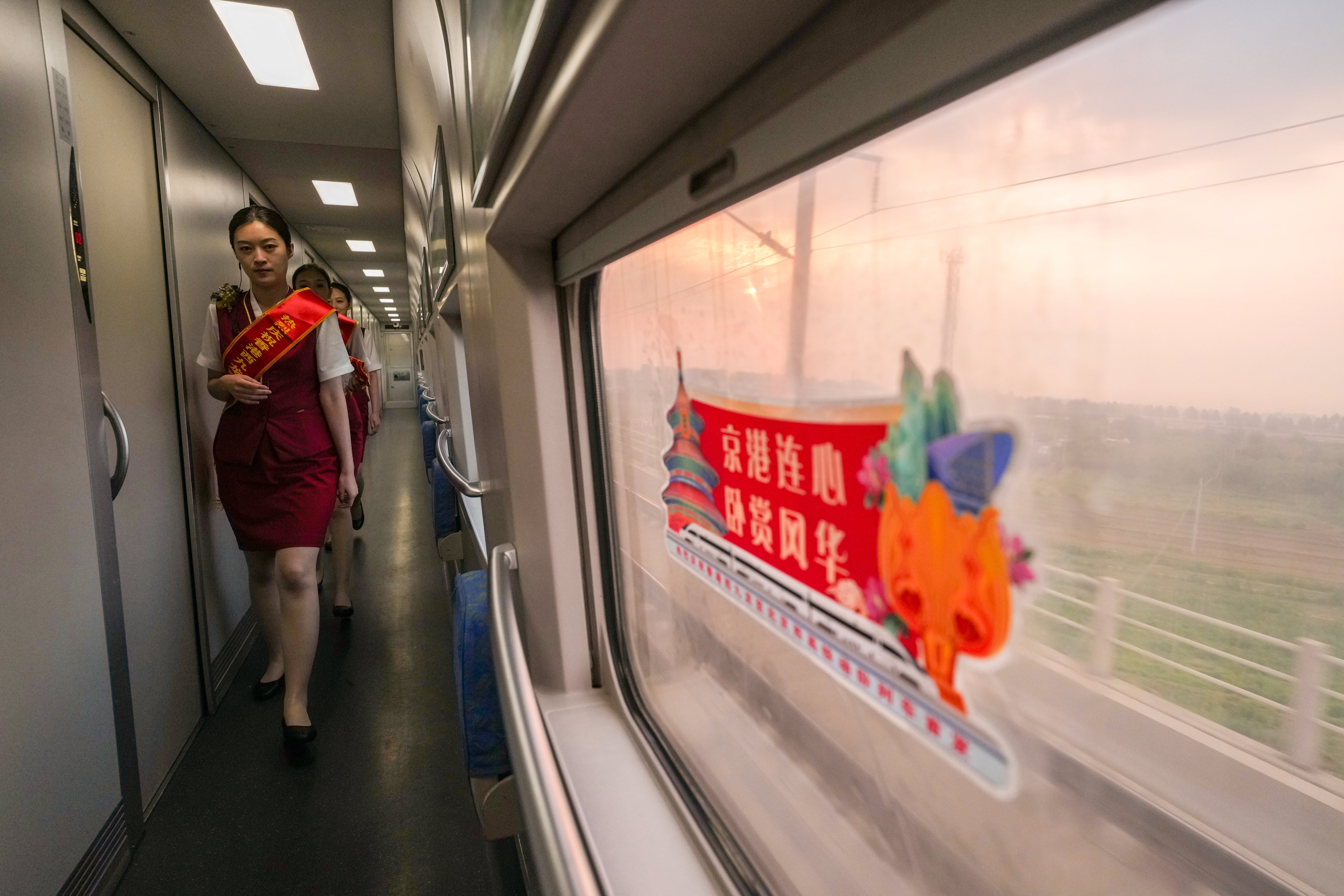 Train attendants walk through the aisle of the sleeper train from Hong Kong to Beijing. Photo: Elson Li