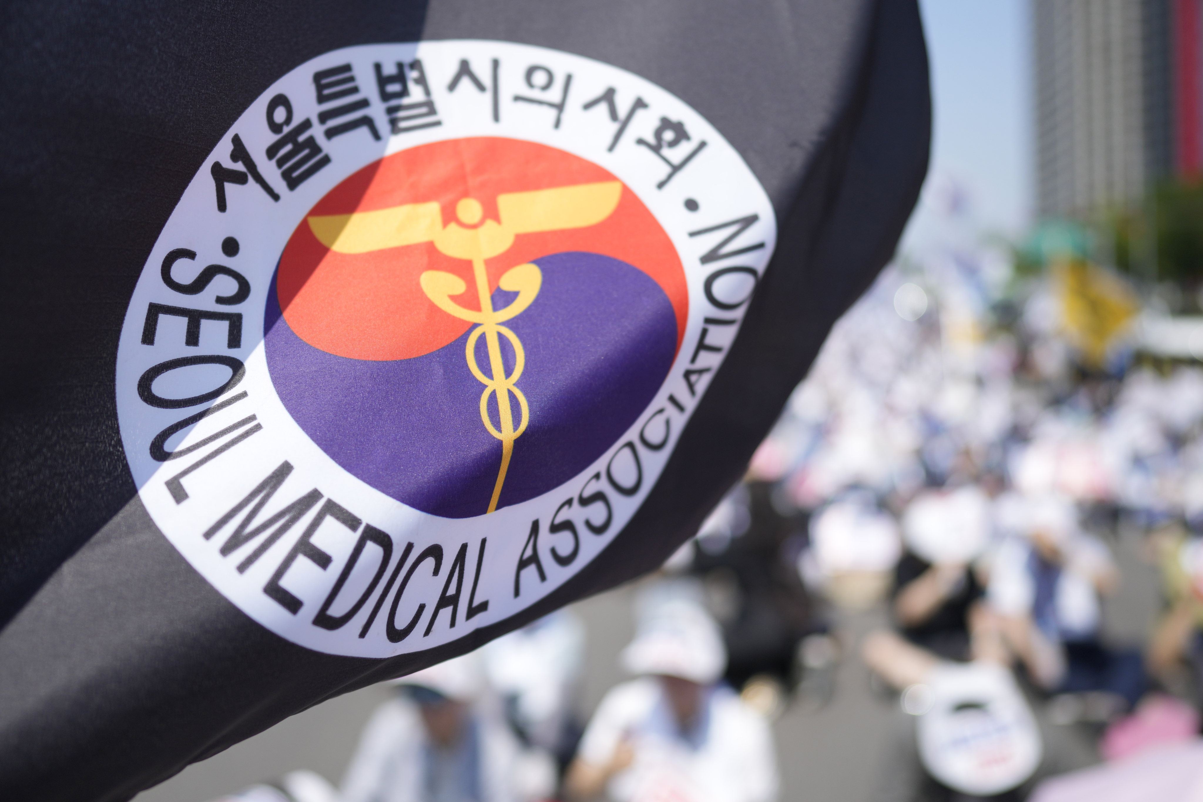 A flag of Seoul Medical Association flutters in the wind during a rally by striking doctors in Seoul on Tuesday. Photo: AP