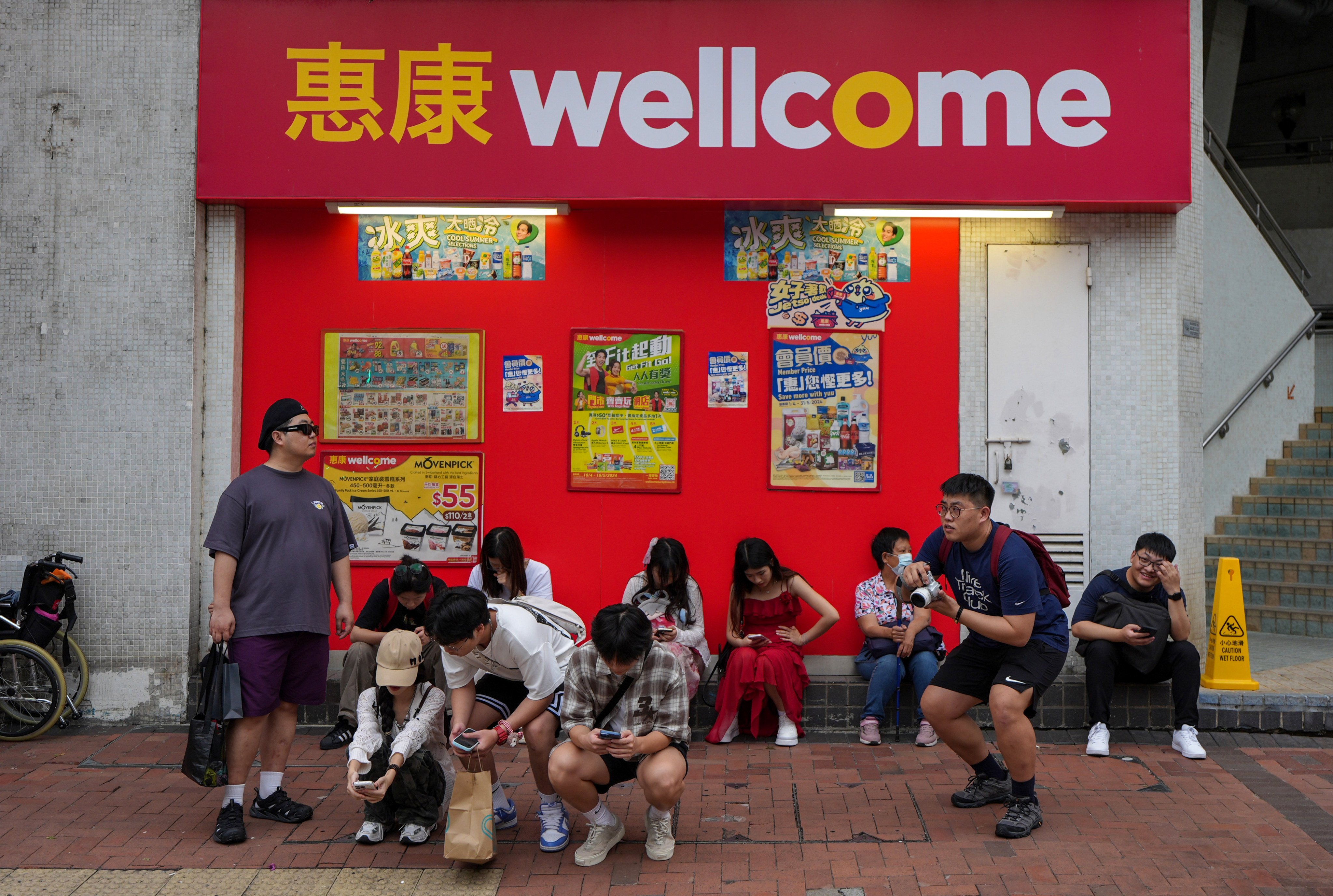 Tourists rest outside a Wellcome supermarket on May 2. As awareness of the harms of ultra-processed foods grows, are the leaders of chains like Wellcome and ParknShop preparing for a future when unhealthy packaged food is no longer in demand? Photo: Eugene Lee