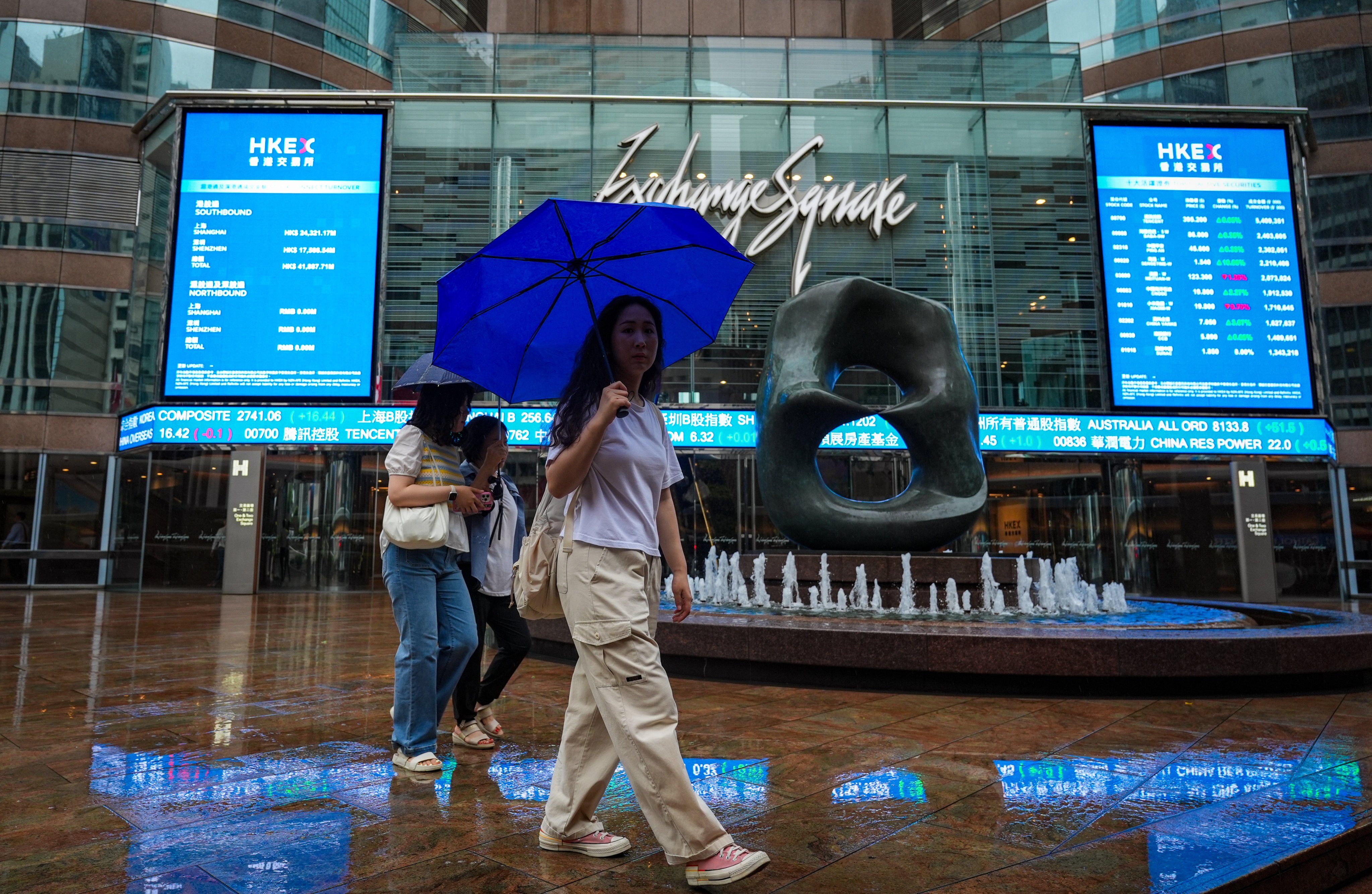 Pedestrians walk past Exchange Square in Central amid rainy and gusty conditions. Photo: Eugene Lee