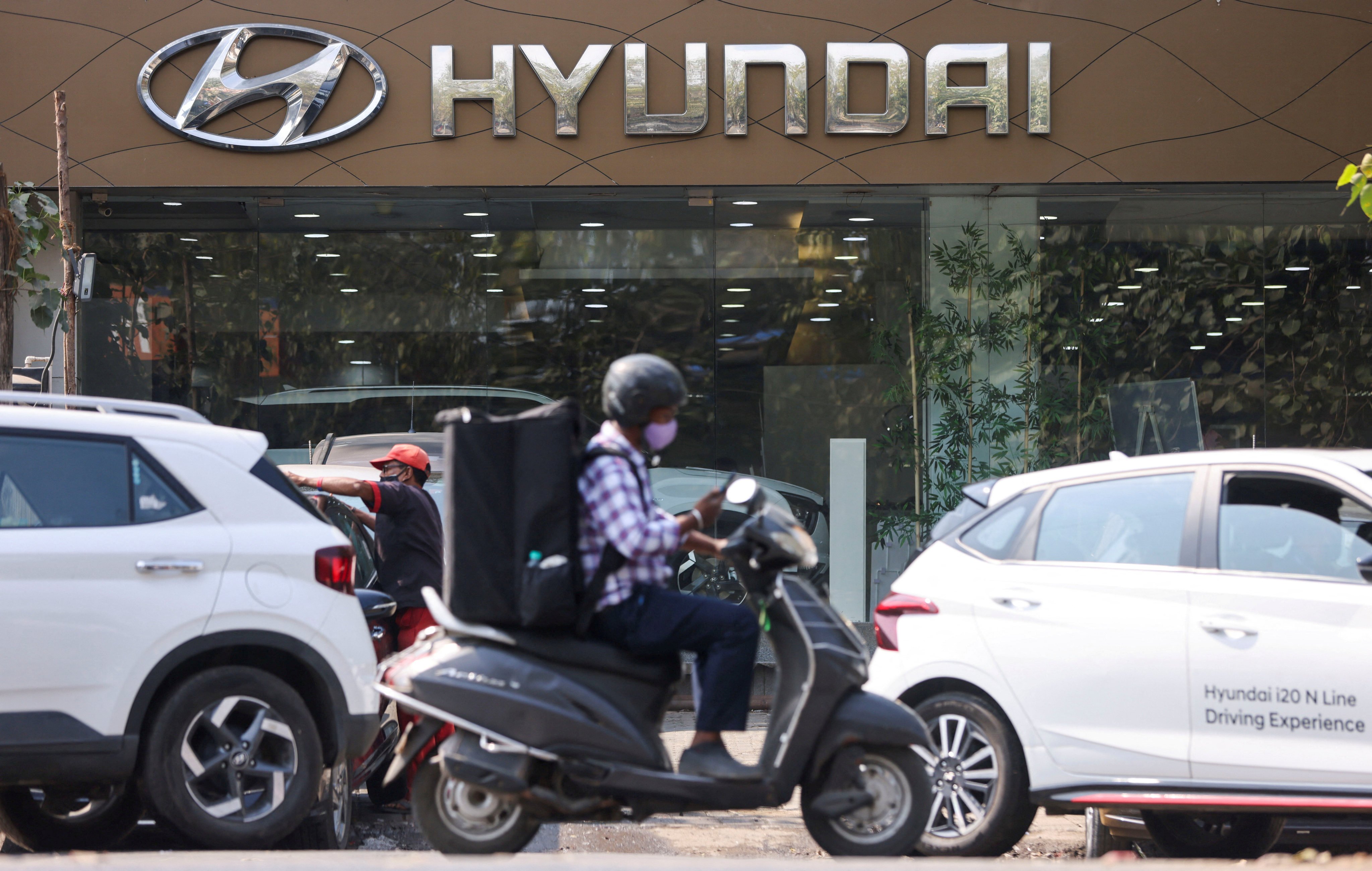 A man rides a scooter past a Hyundai dealership in Mumbai. South Korea’s Hyundai is the second-largest carmaker in India. Photo: Reuters