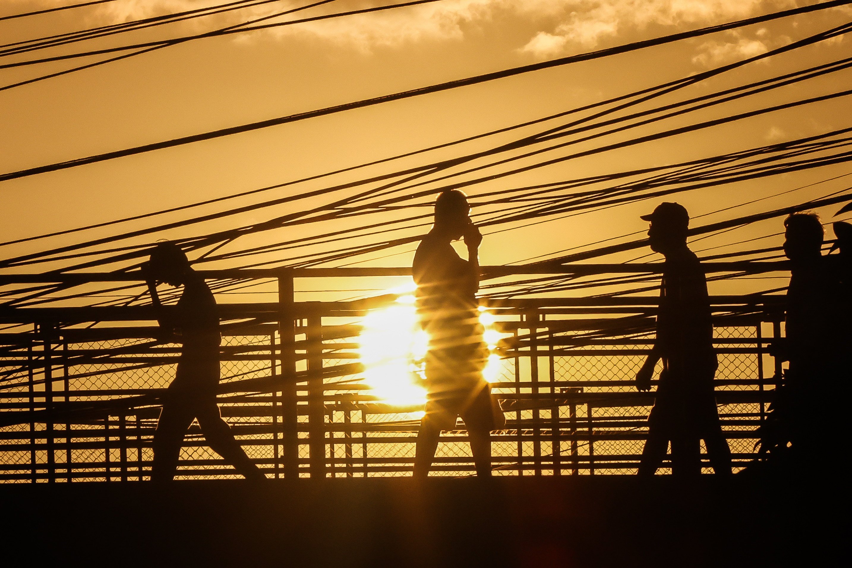 People walk through scorching heat in Quezon City during April’s intense heatwave, which officials have partly blamed for the Philippines’ current power crisis. Photo: Xinhua