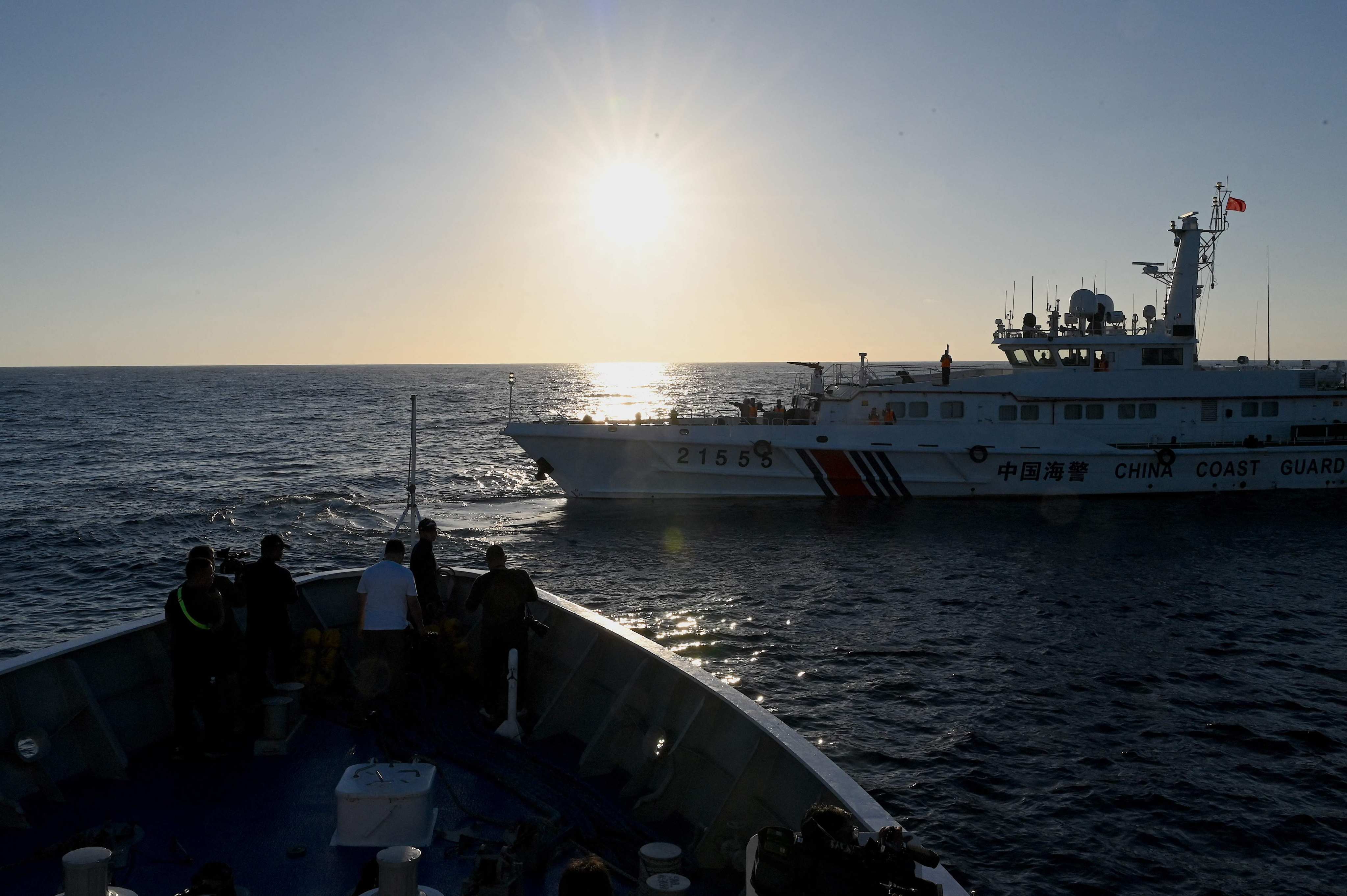 A China coastguard vessel sails in front of the BRP Sindangan of the Philippine coastguard during a supply mission to the Second Thomas Shoal in the disputed South China Sea. Photo: AFP