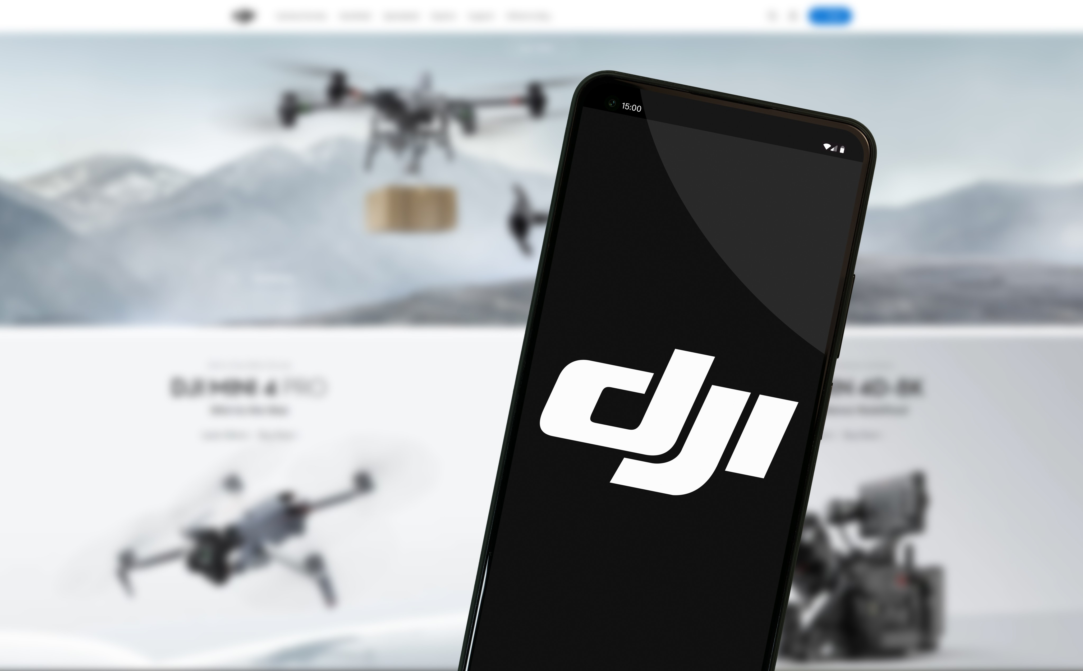 The DJI logo on a smartphone screen in front of the company’s website. Photo: Shutterstock Images