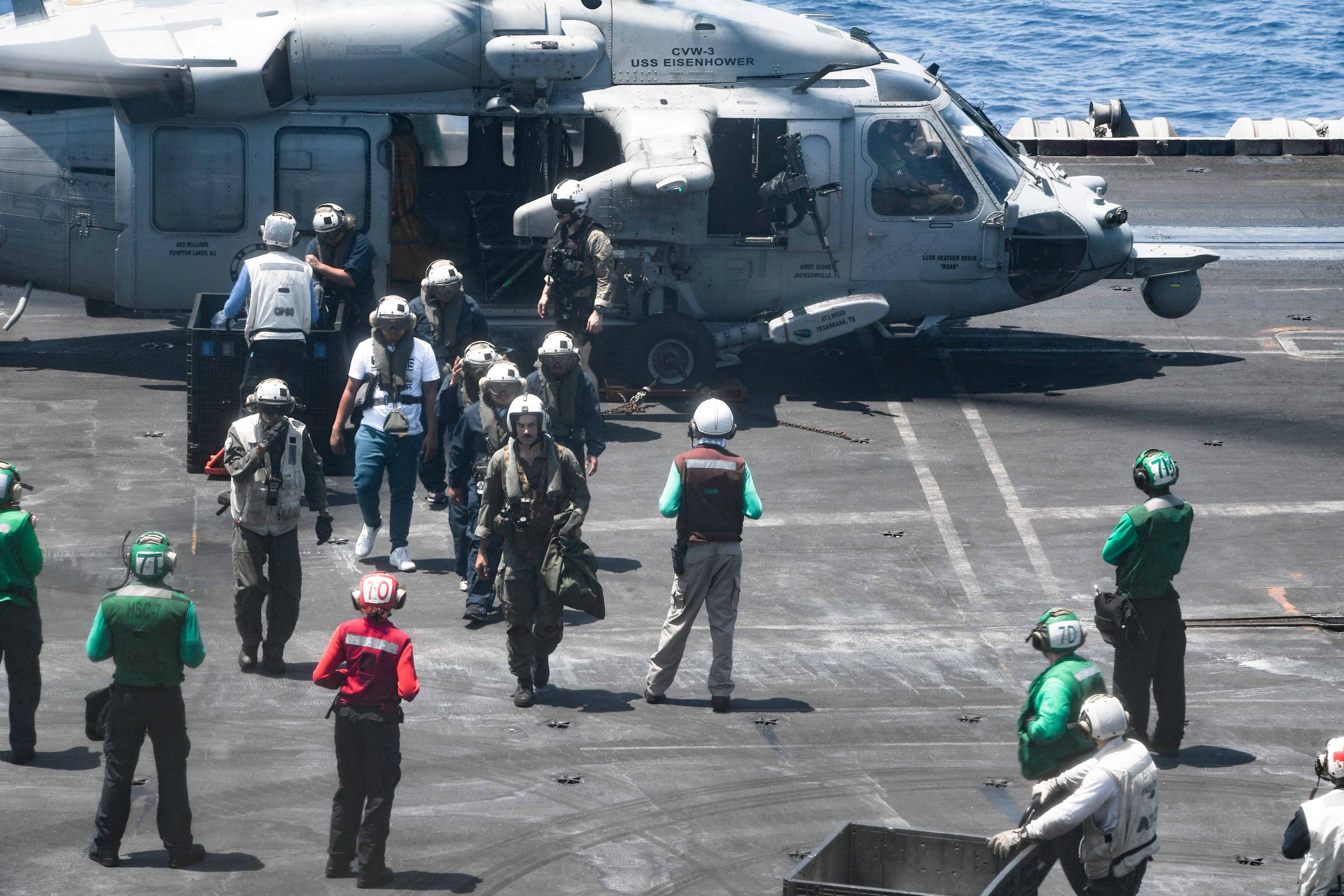 US crew from the Dwight D. Eisenhower Carrier Strike Group assist sailors rescued from the M/V Tutor. Photo: US Navy via Reuters 