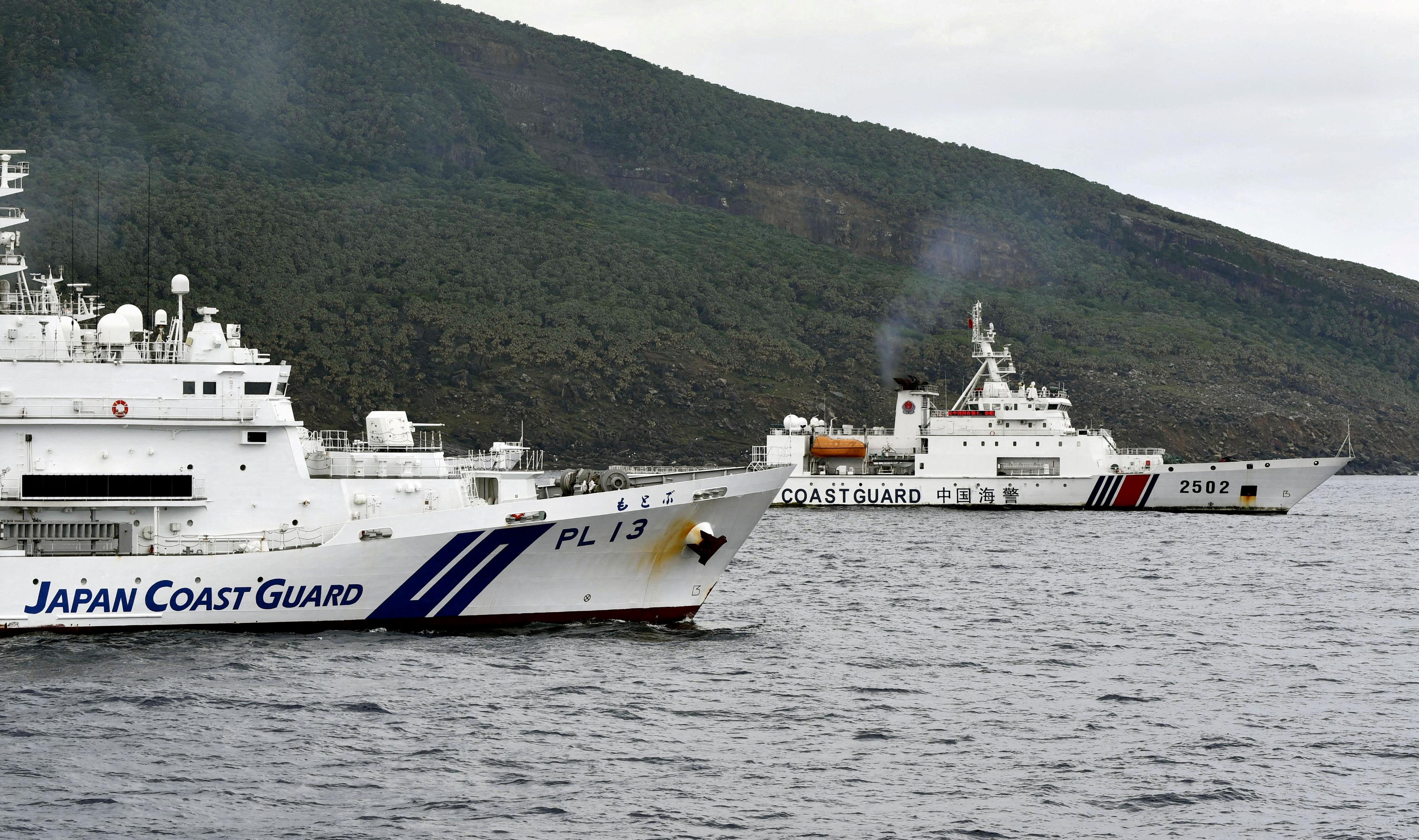 A China Coast Guard vessel sails near a Japan Coast Guard vessel off Uotsuri Island, one of a group of disputed islands called Senkaku Islands in Japan, also known in China as Diaoyu Islands, in the East China Sea on April 27. Photo: Kyodo via Reuters