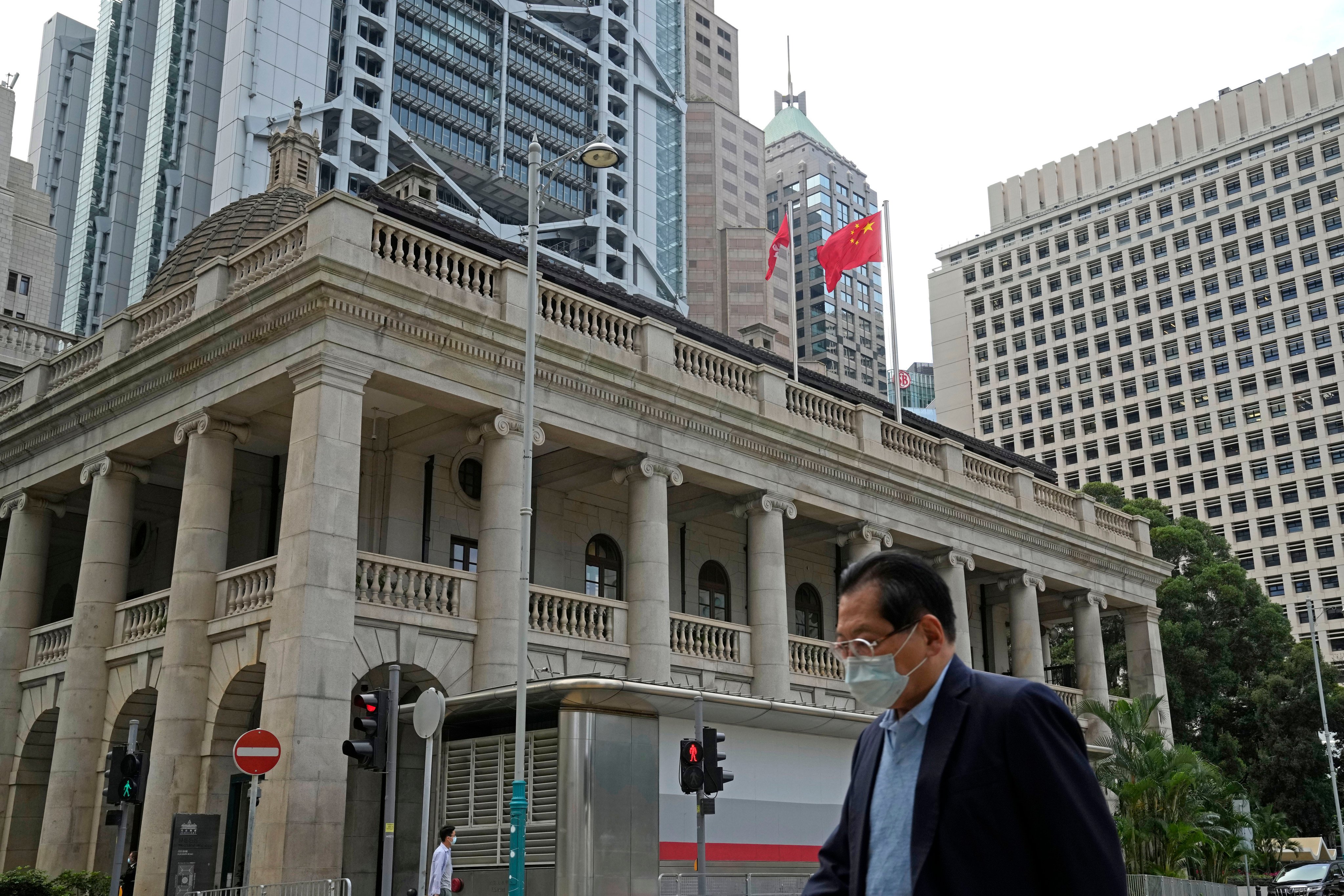 A pedestrian passes the Court of Final Appeal in Hong Kong in 2022. Two British judges have resigned from the city’s top court, and a Canadian judge is retiring. Photo: AP