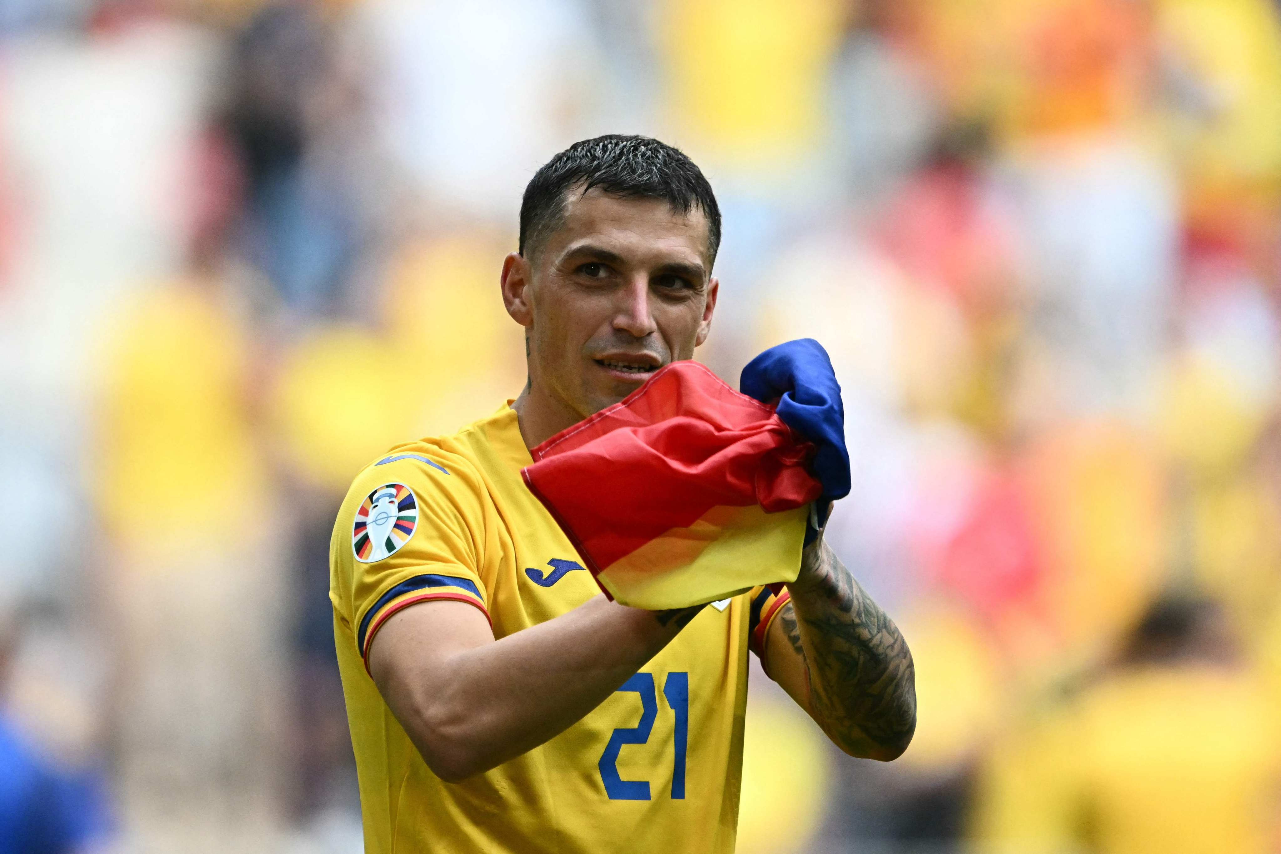 Romania’s midfielder #21 Nicolae Stanciu celebrates after winning 3:0 the UEFA Euro 2024 Group E football match between Romania and Ukraine at the Munich Football Arena in Munich on June 17, 2024. (Photo by Fabrice COFFRINI / AFP)