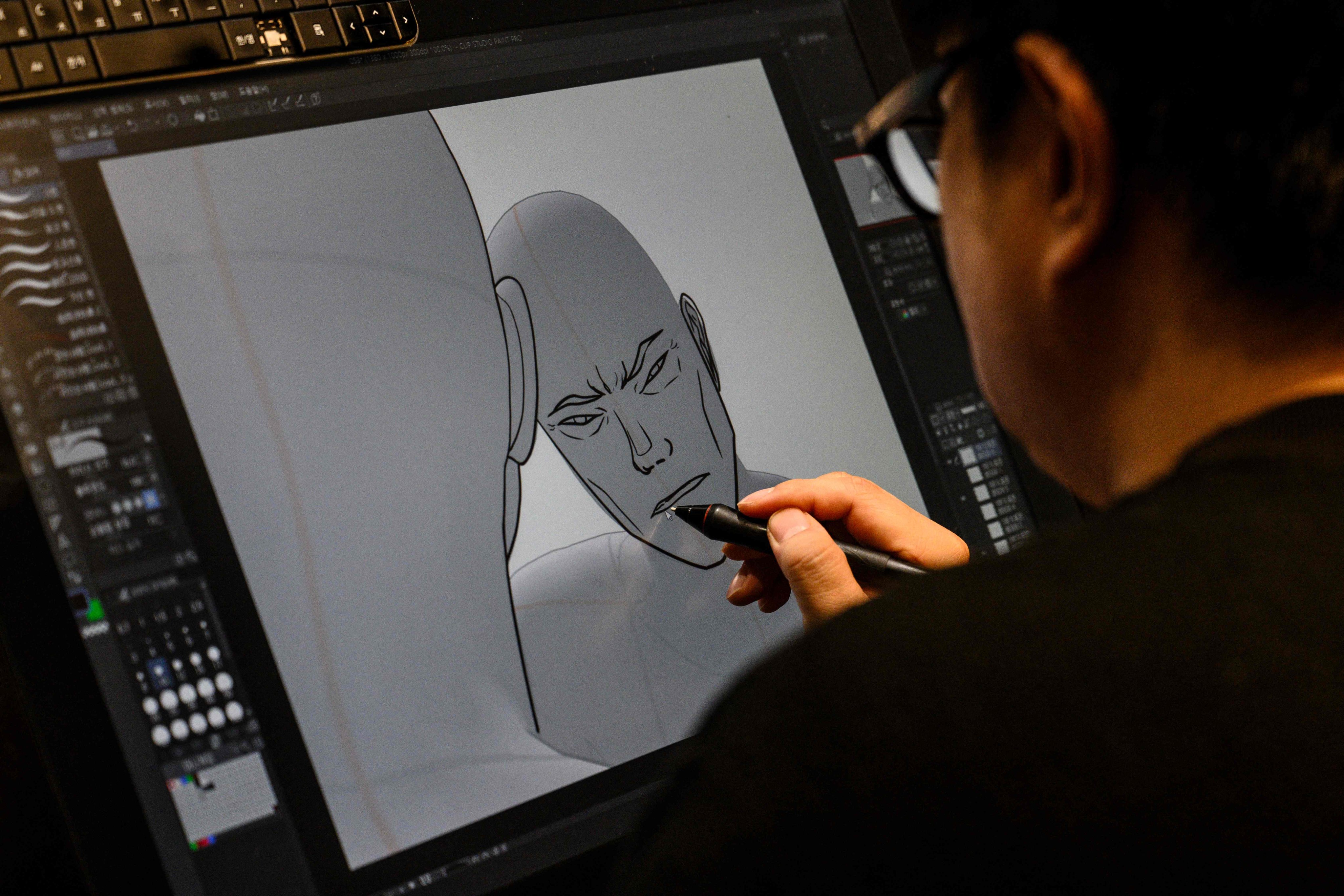 South Korean webtoon artist Bae Jin-soo draws a character at his studio in Seoul. The already multi-billion dollar business looks set to grow further as its biggest platform, Webtoon Entertainment, files for a Nasdaq IPO. Photo: AFP