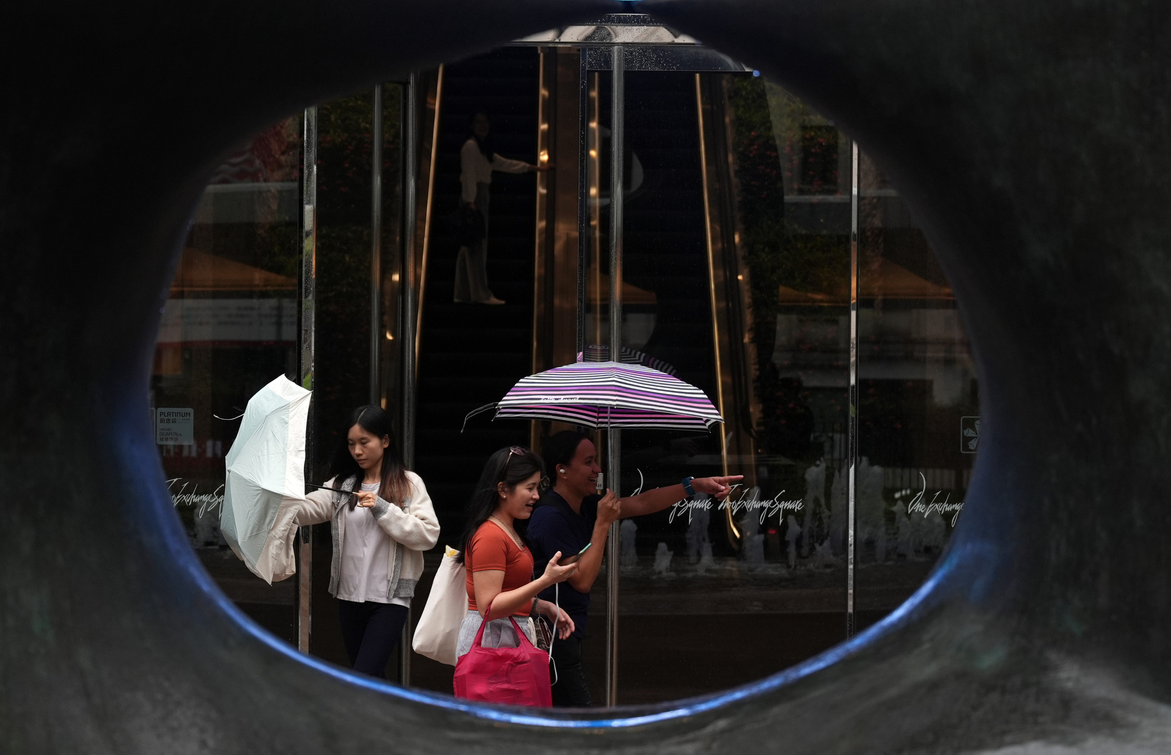 Pedestrians walk past Exchange Sqaure in Central. Government officials and Hong Kong Exchange and Clearing (HKEX) expects to keep stock and derivatives markets open during typhoons this year. Photo: Eugene Lee