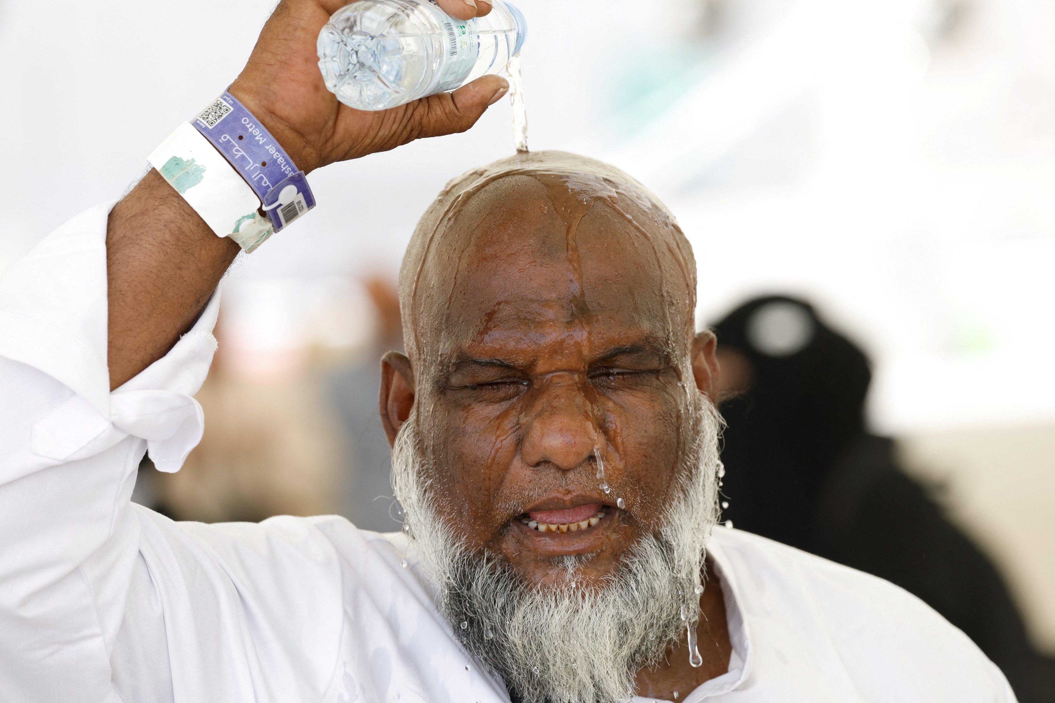 A pilgrim pours water on his head to cool down from the extreme heat during this year’s haj. Photo: Reuters