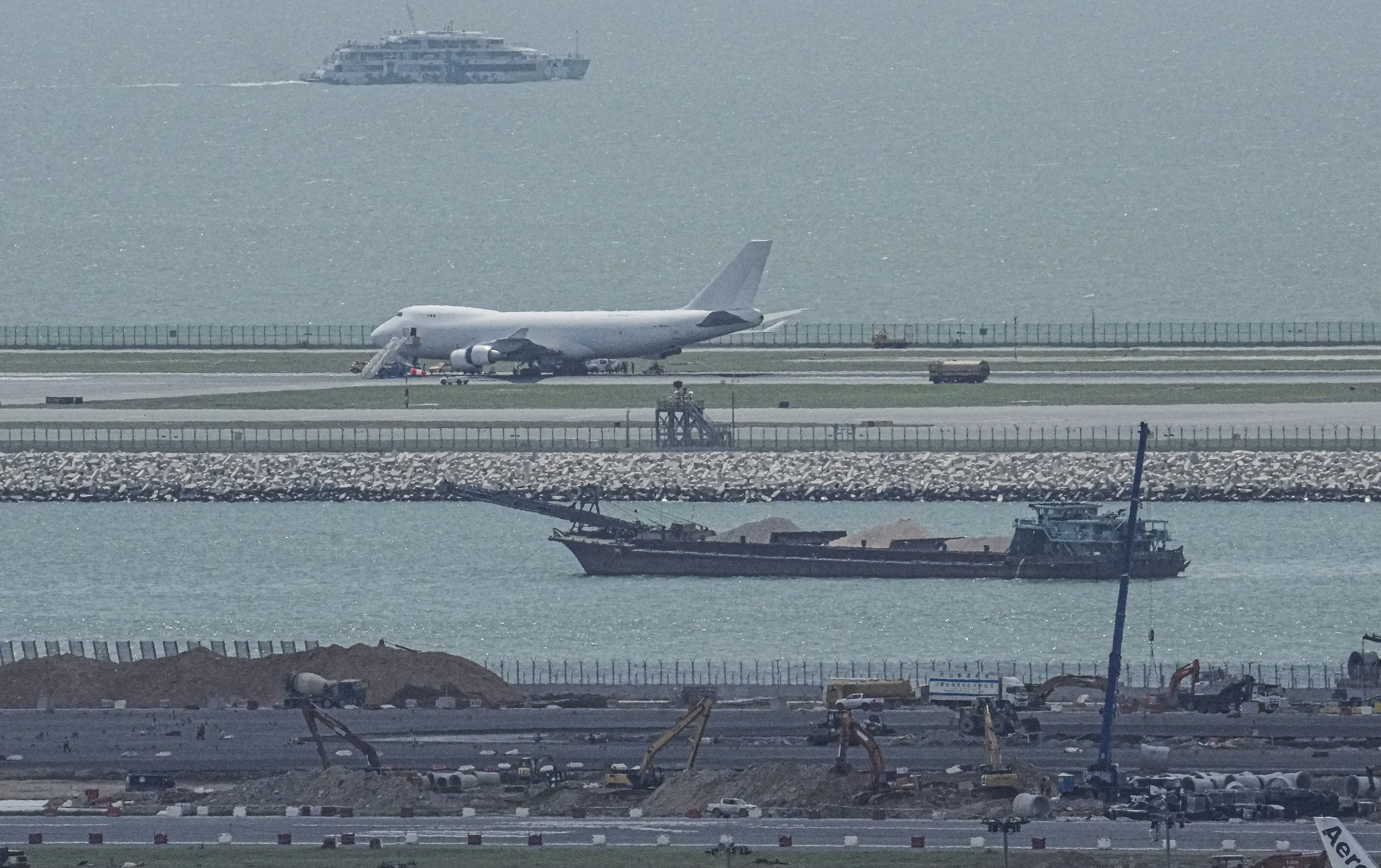 A cargo plane, which burst a tyre during an emergency landing at Hong Kong International Airport, is seen parked on the north runway. Photo: May Tse