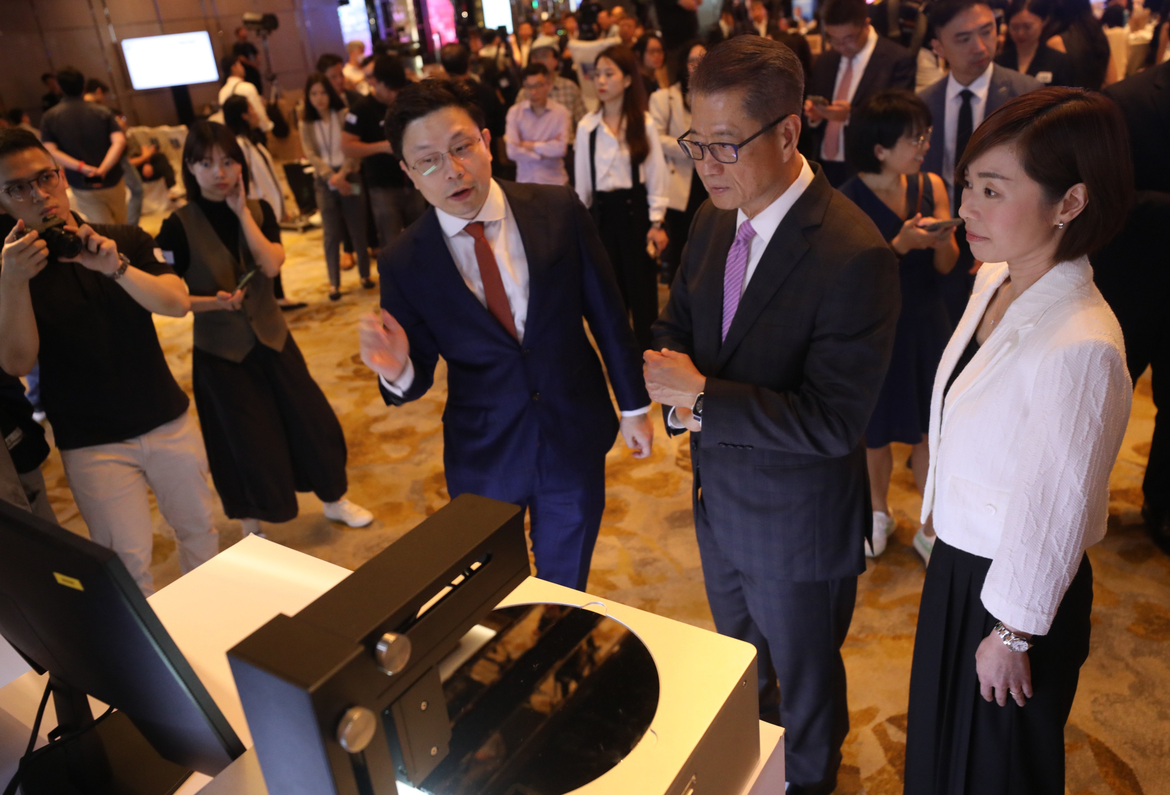 AI company Smartmore’s founder and chairman Jia Jiaya chats with Financial Secretary Paul Chan Mo-Po and Hong Kong Investment Corporation (HKIC) CEO Clara Chan Ka-chai on June 12 at the Ritz-Carlton Hotel, where a strategic partnership deal was signed between Hong Kong’s wealth fund and the Hong Kong unicorn. Photo: Sun Yeung