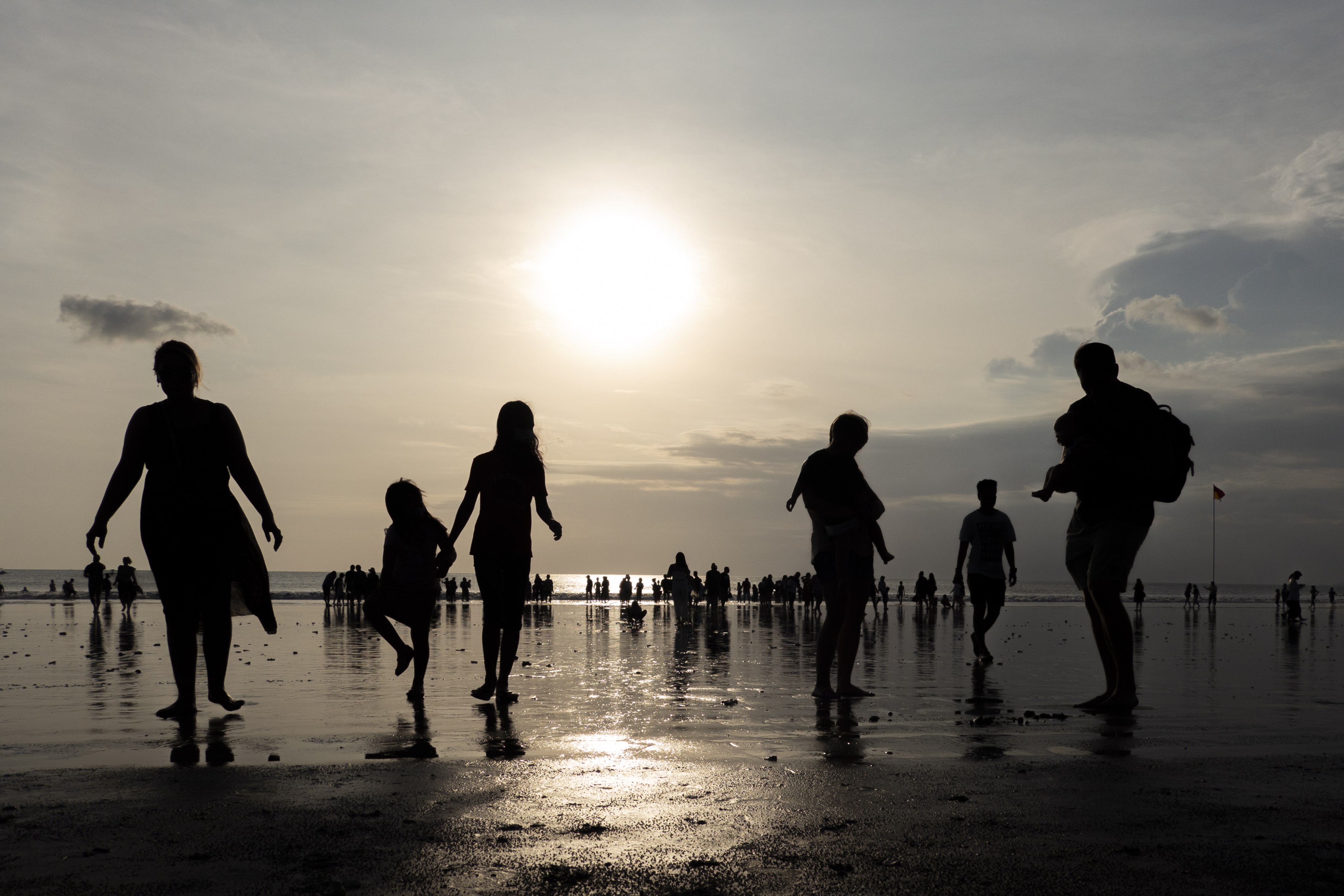 Tourists walk at a beach in Kuta, Bali. A German visitor is accused of involving in a string of assaults and property damage in the holiday hotspot. Photo: EPA-EFE