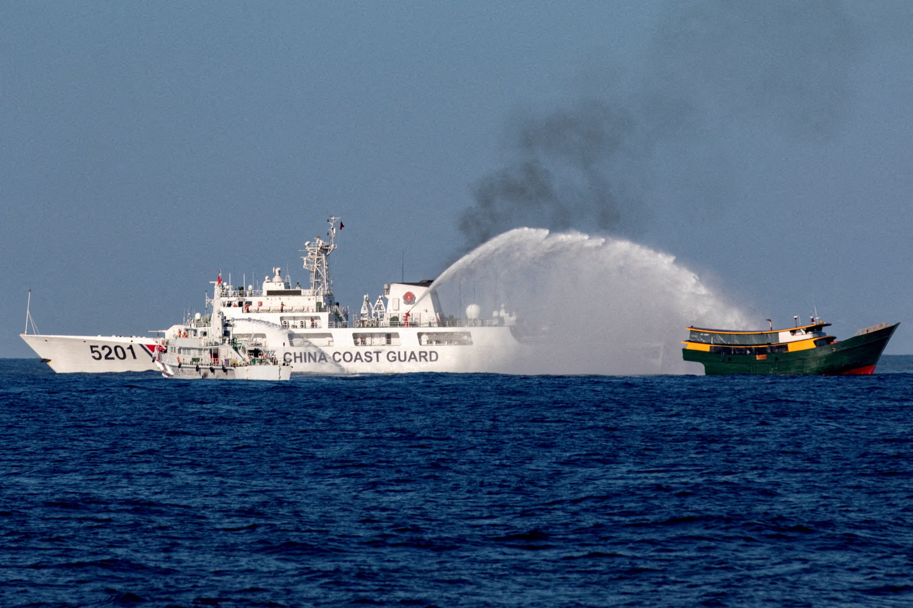 A Chinese coastguard vessel fires a water cannon towards a Philippine resupply vessel as it makes its way to the Second Thomas Shoal in the South China Sea in March. Photo: Reuters 