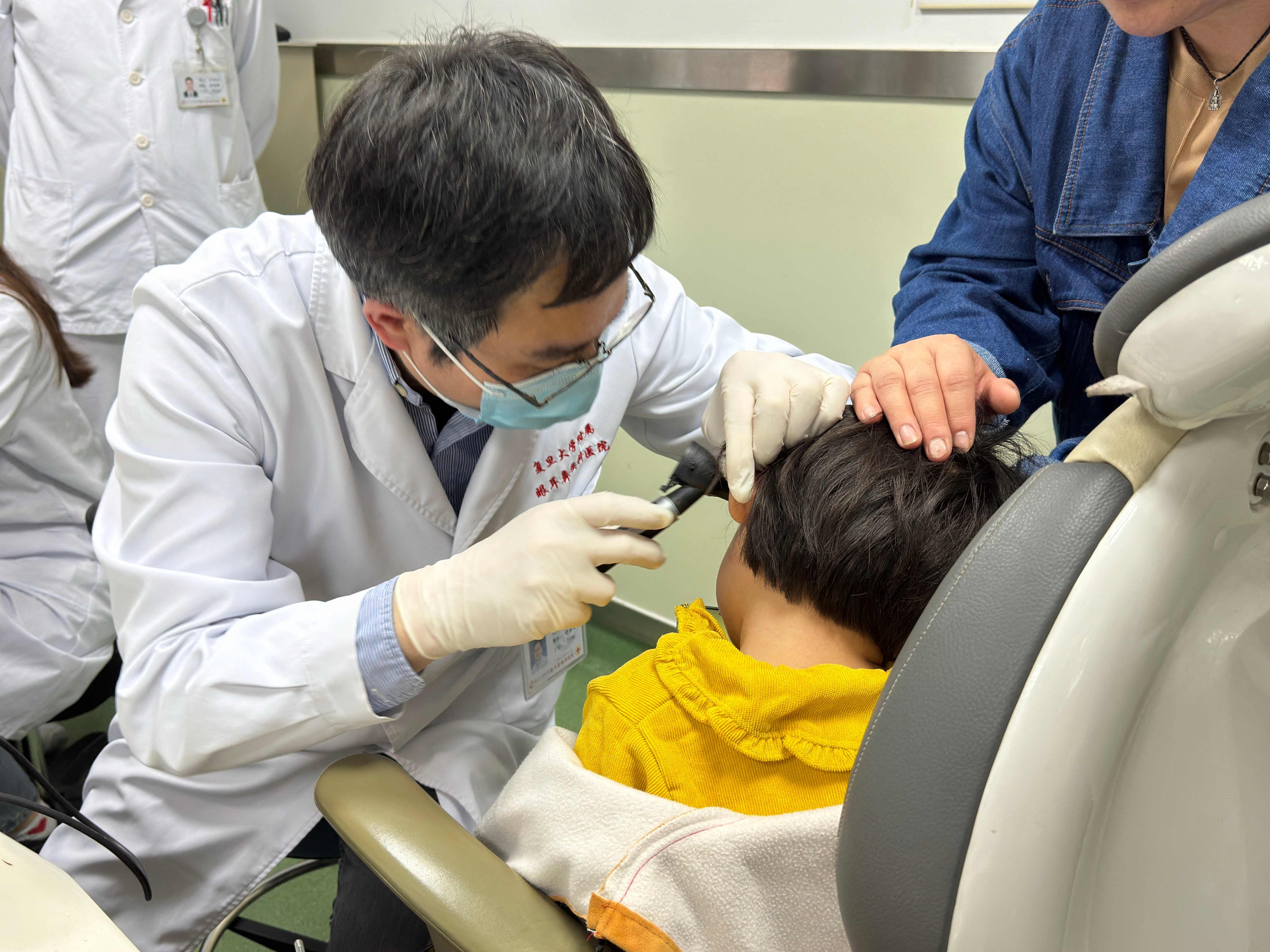 Dr Shu Yilai examines a young patient at the Eye & ENT Hospital of Fudan University. Photo: AFP / Eye & ENT Hospital of Fudan University