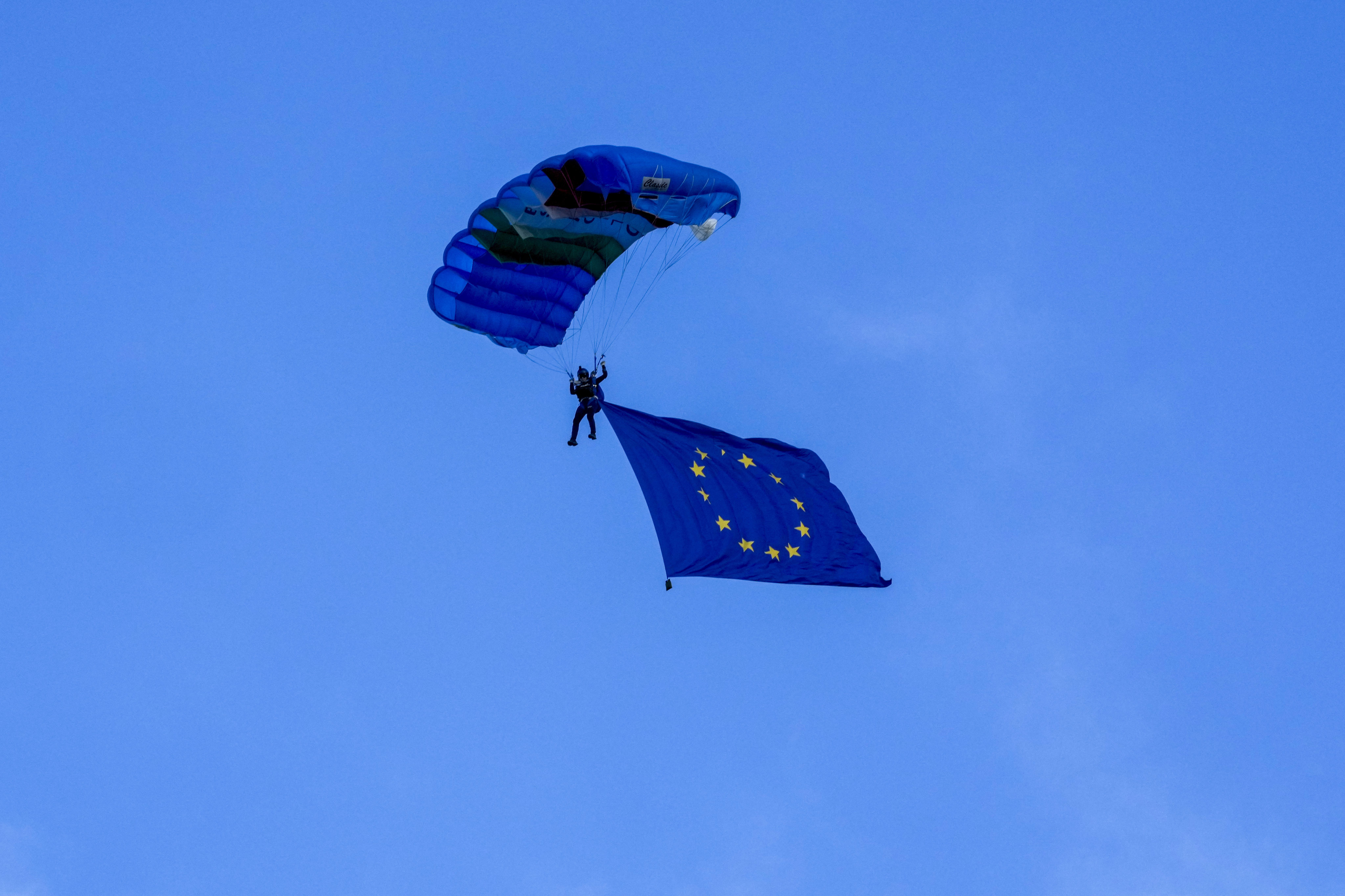 A parachuter carries a European Union flag during a skydiving demonstration at the G7 summit in Italy. Leaders from the 27-nation bloc agreed last year that accession negotiations should start with both Ukraine and Moldova. Photo: AP