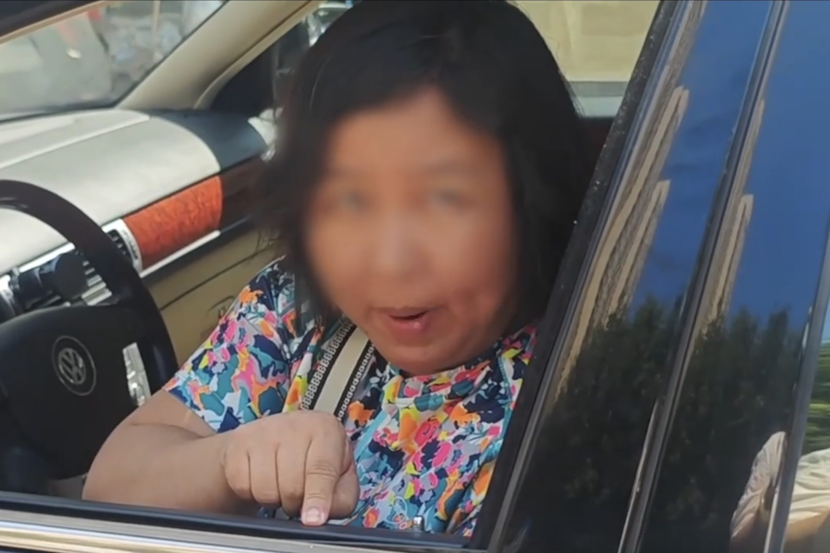 A video of a Beijing woman identified as Yu Qi blocking traffic has drawn attention to her behaviour and also what diplomatic immunity allows. Photo: Xigua News