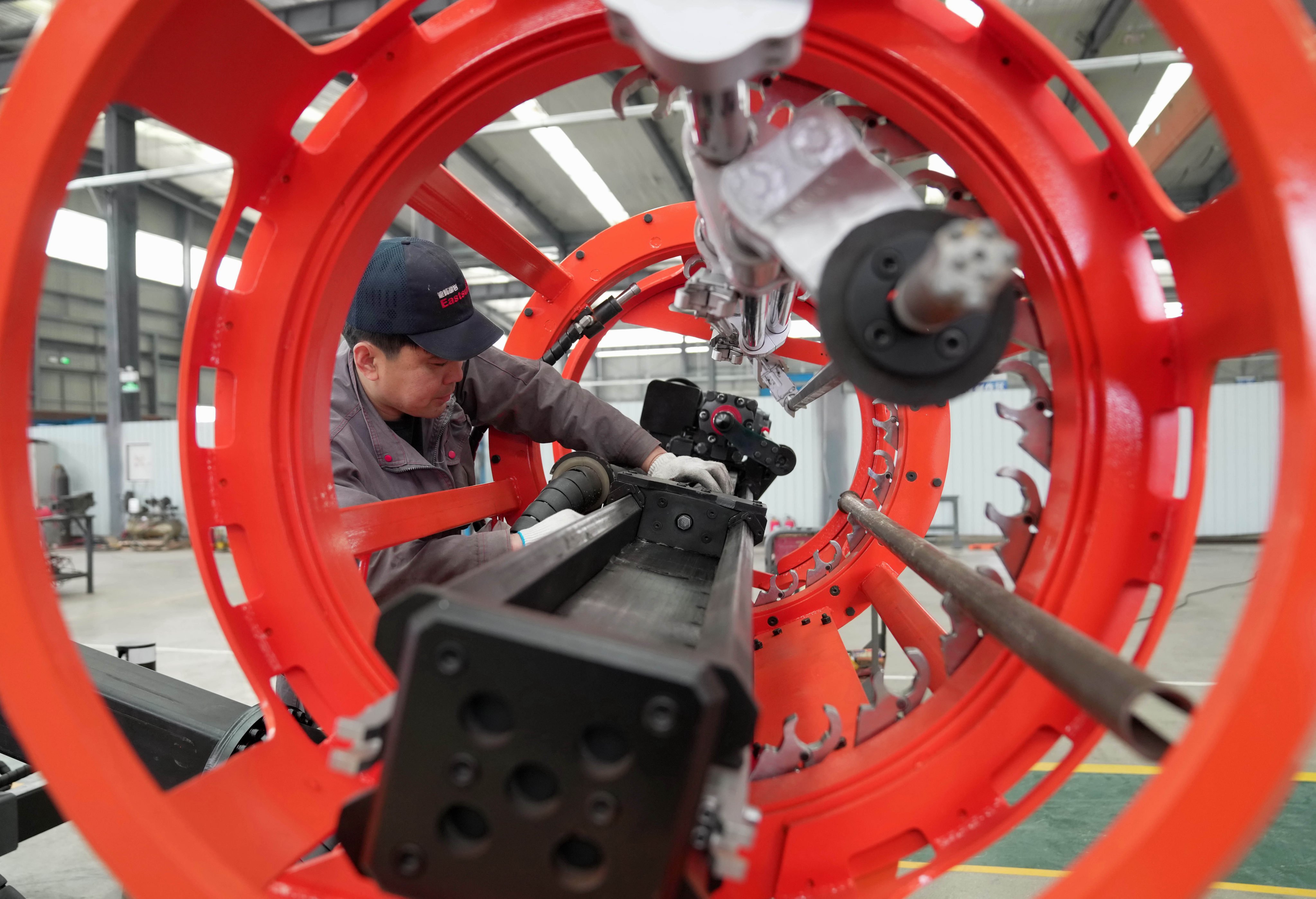 A man works at a workshop of a mechanical equipment enterprise in north China’s Hebei Province. Photo: Xinhua