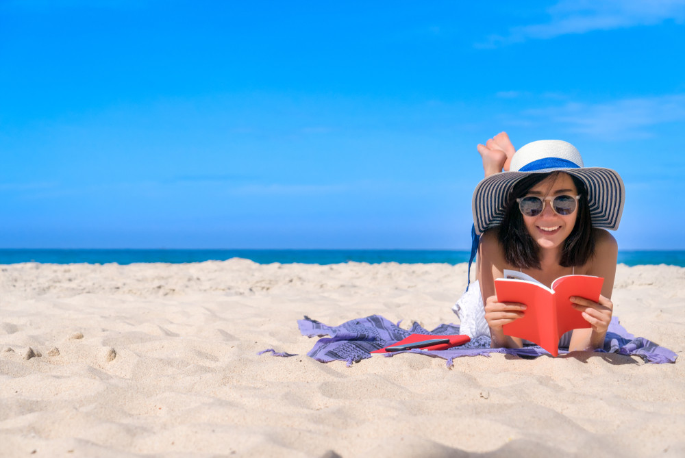 Check out our list of light-hearted books that are the perfect accompaniment for a day at the beach. Photo: Shutterstock 