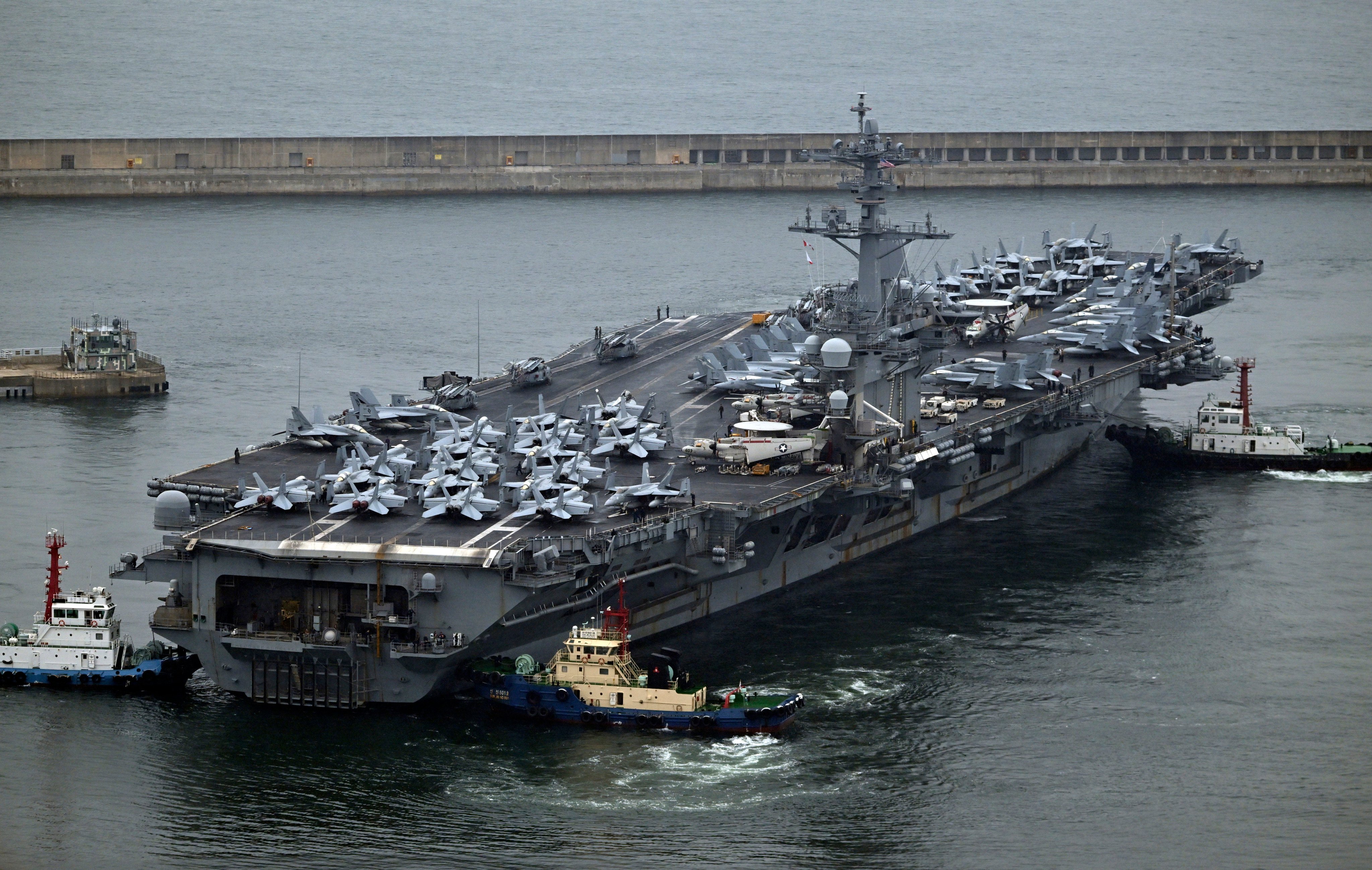 The USS Theodore Roosevelt, a nuclear-powered aircraft carrier, is anchored in Busan, South Korea, on Saturday. Photo: Pool via AP