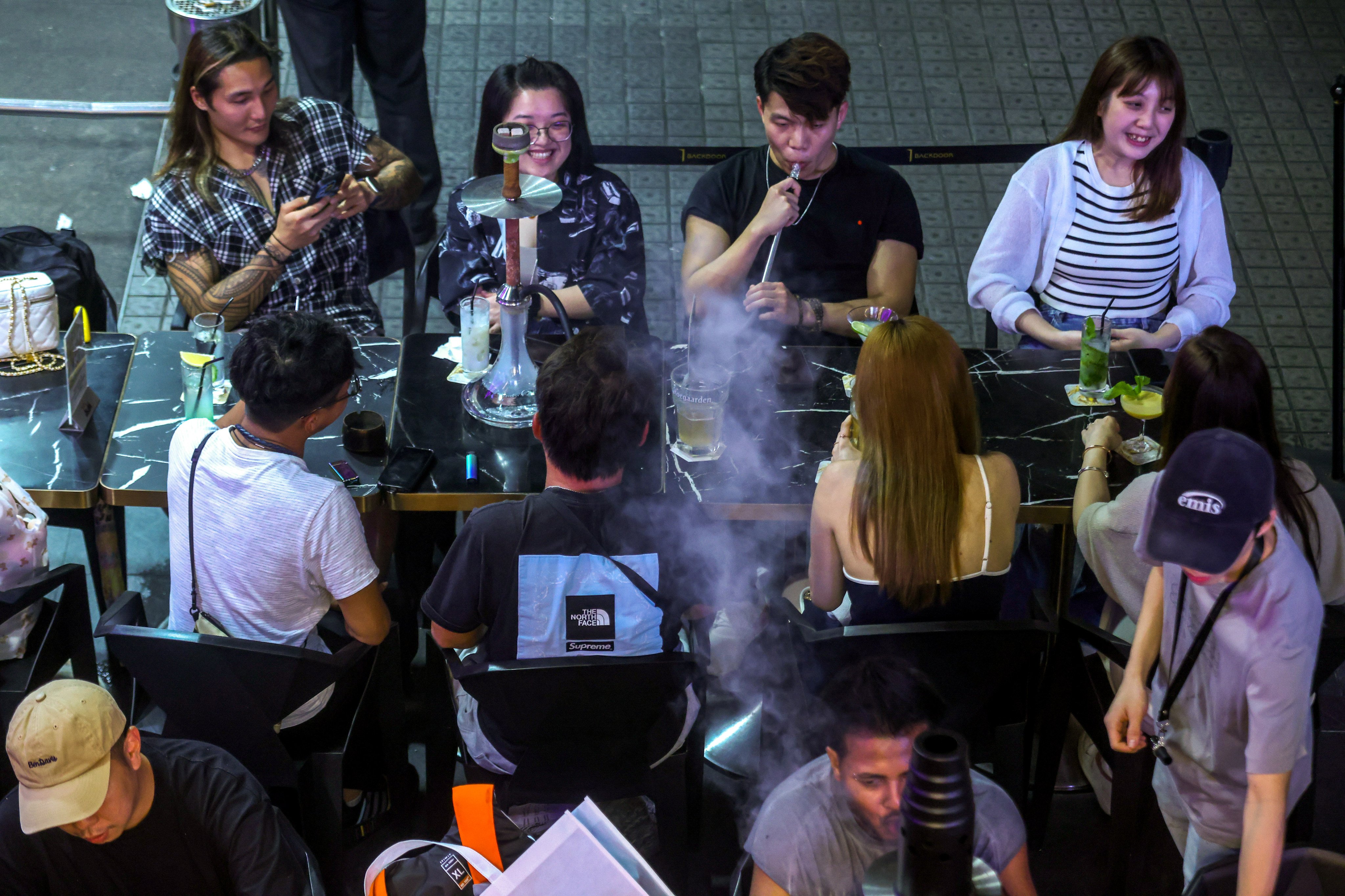 Smokers enjoy shisha on Knutsford Terrace in Tsim Sha Tsui. Photo: Jonathan Wong