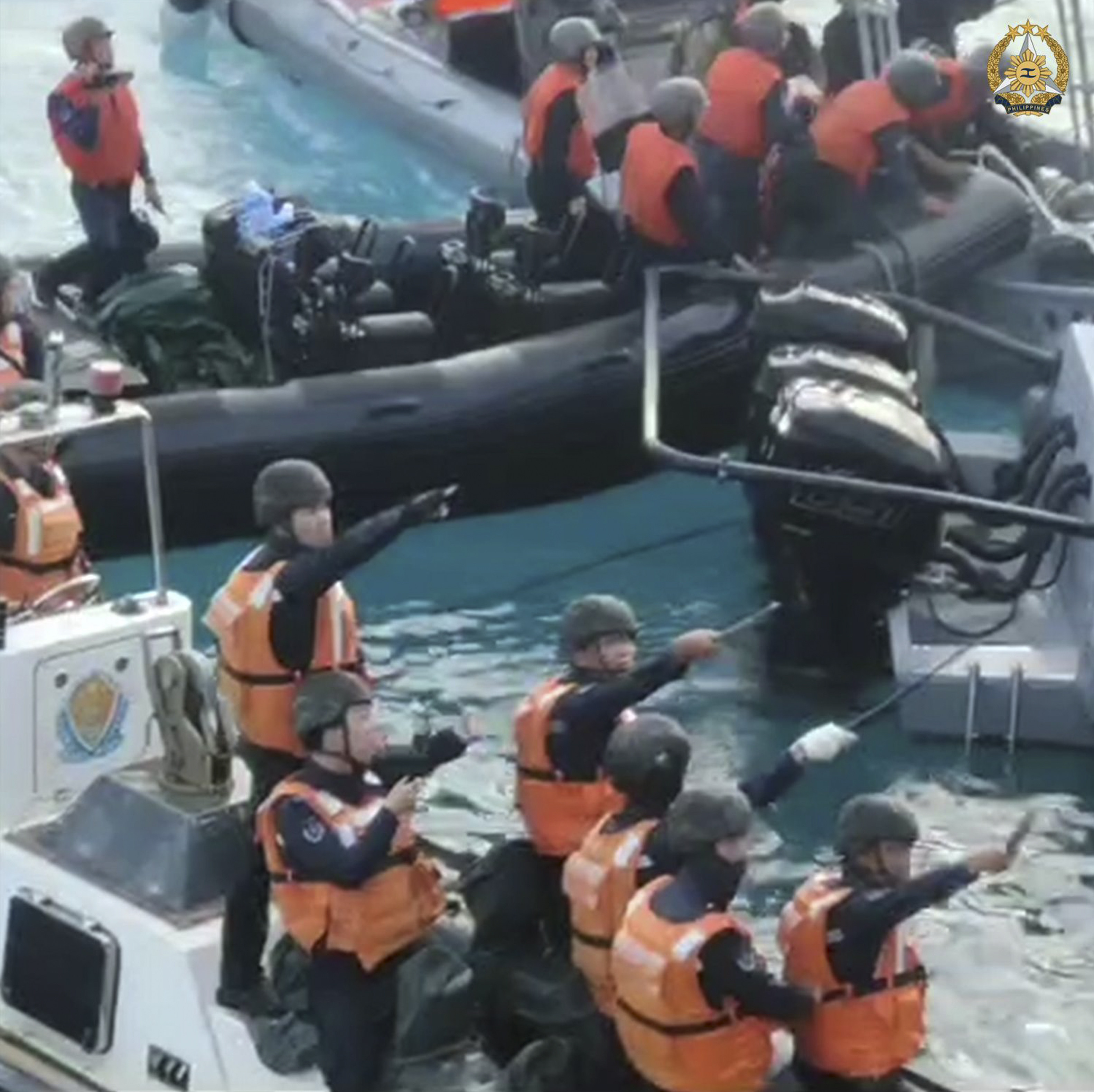 Chinese coastguard personnel brandish what appear to be knives, machetes and other weapons as they approach Philippine troops in the South China Sea on June 17. Photo: Armed Forces of the Philippines/Handout via AP