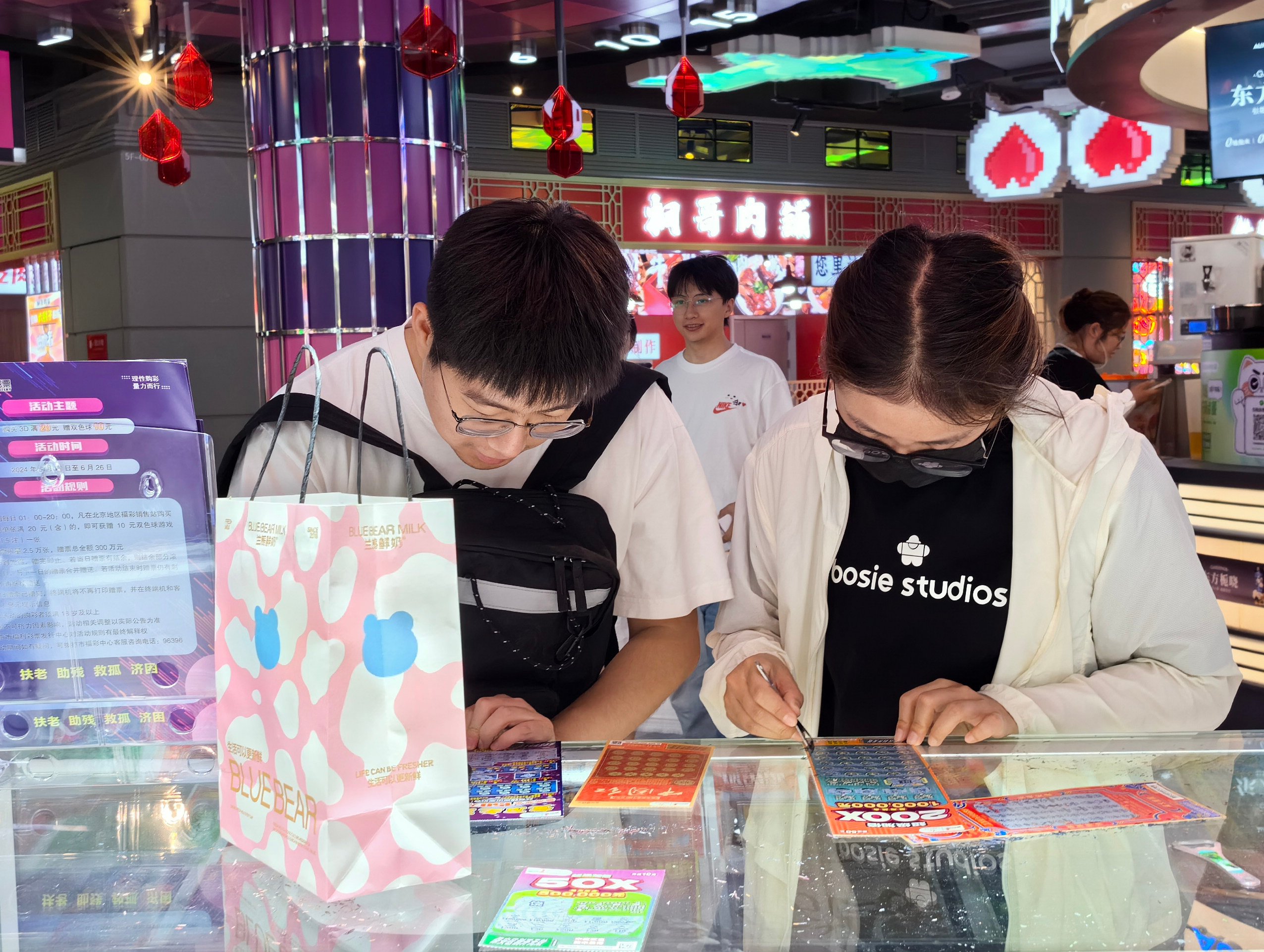 Young people buy lottery tickers in Beijing. Photo: Simon Song